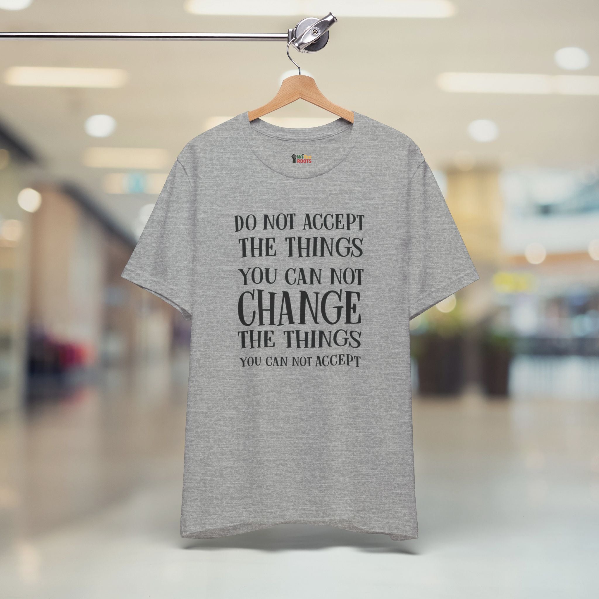 Grey t-shirt with motivational quote on a hanger in a store setting