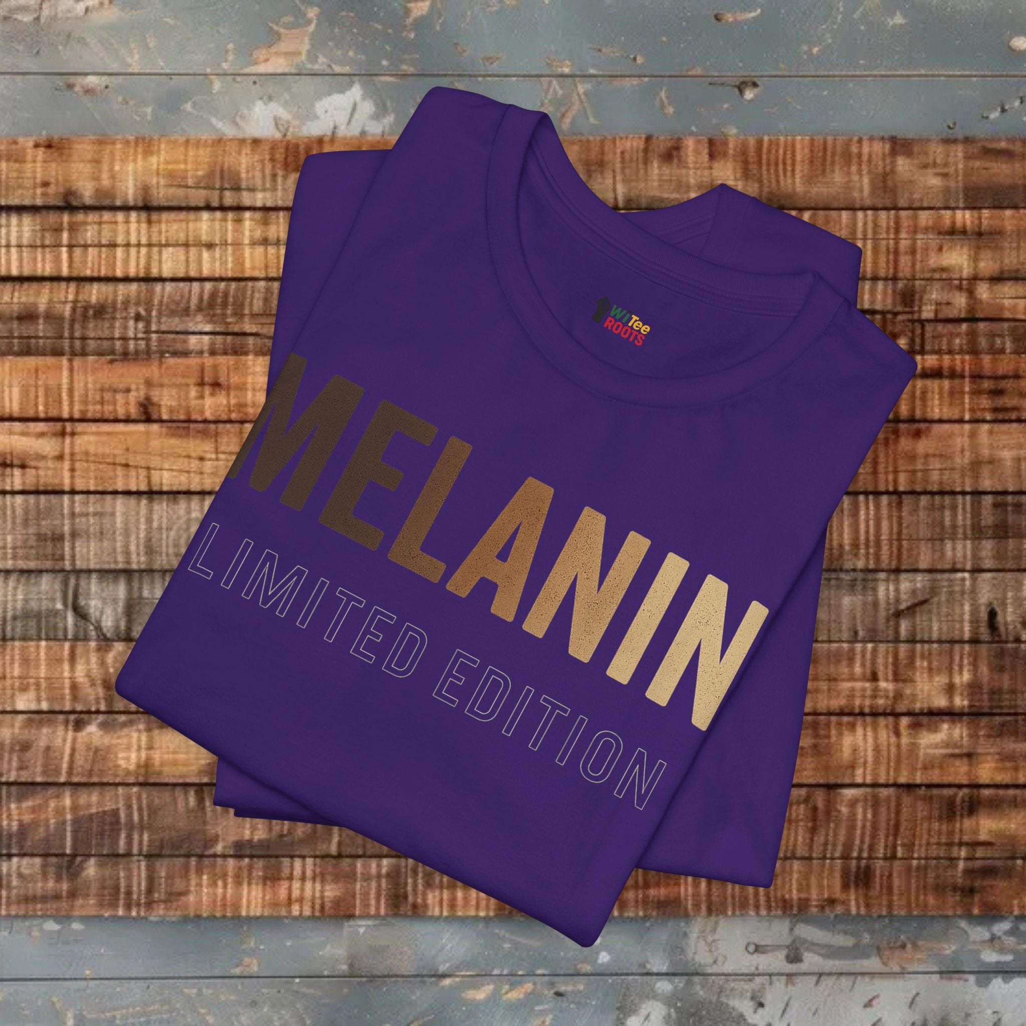 Purple t-shirt with 'MELANIN LIMITED EDITION' text on a wooden surface