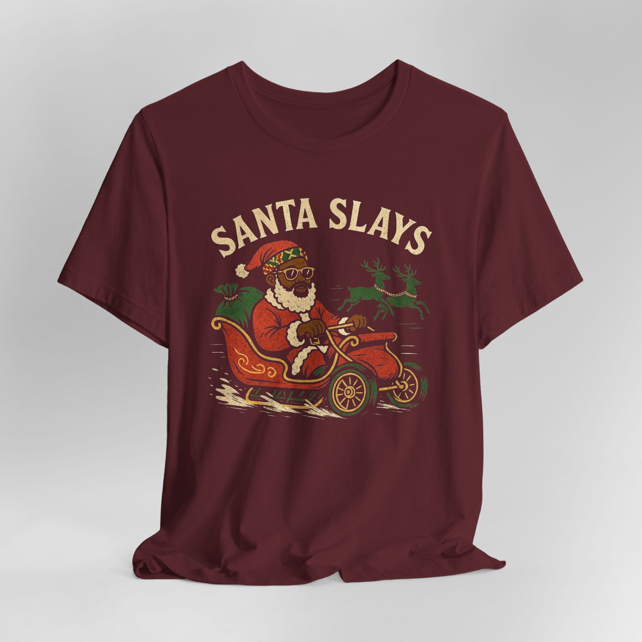 Maroon t-shirt with a graphic of Santa driving a car and the text 'Santa Slays' on a white background.