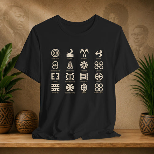 A black short-sleeve t-shirt with a 4x4 grid of white tribal symbols and names, displayed on a wooden shelf with potted plants and a textured background.