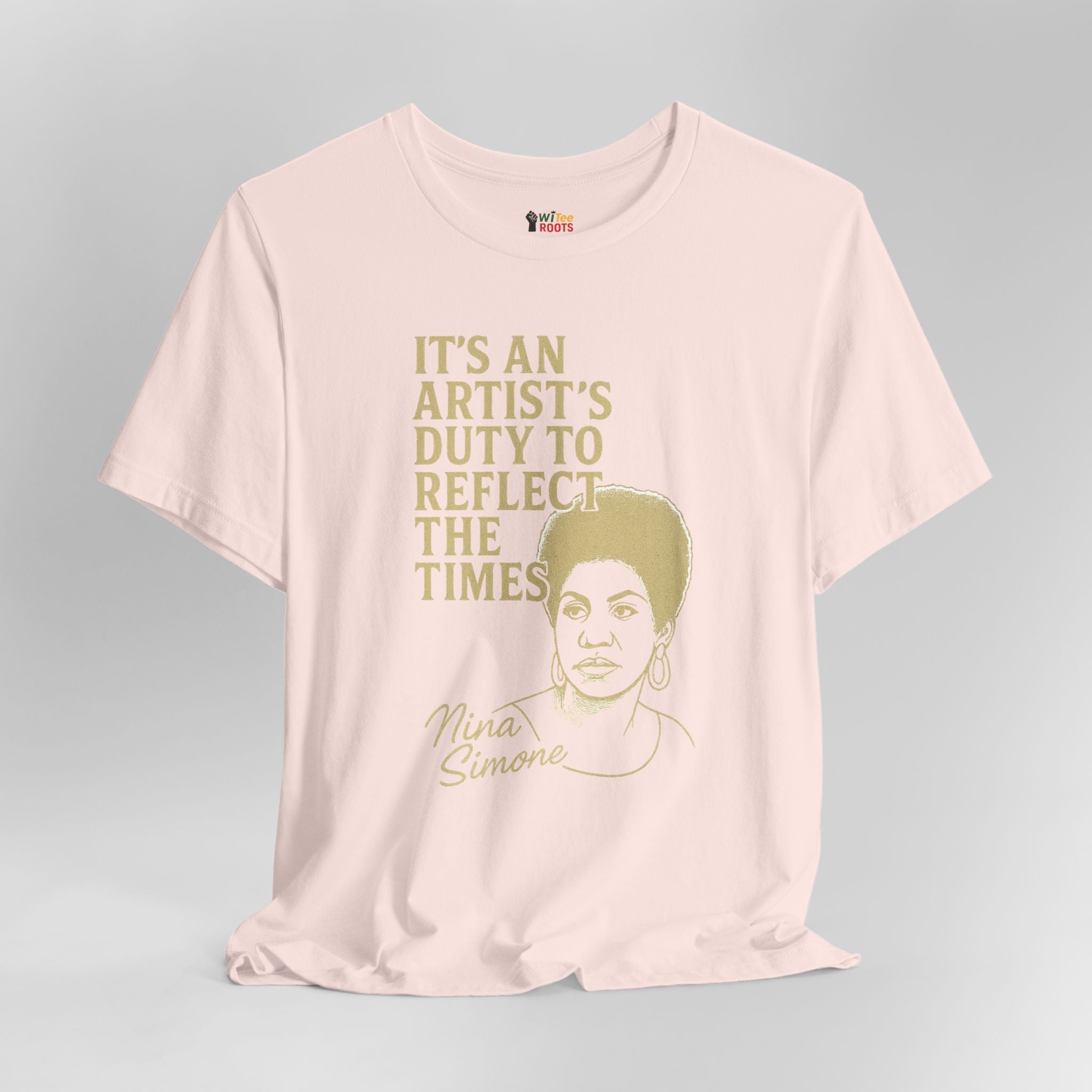 Pink t-shirt with a graphic of Nina Simone and text on a gray background