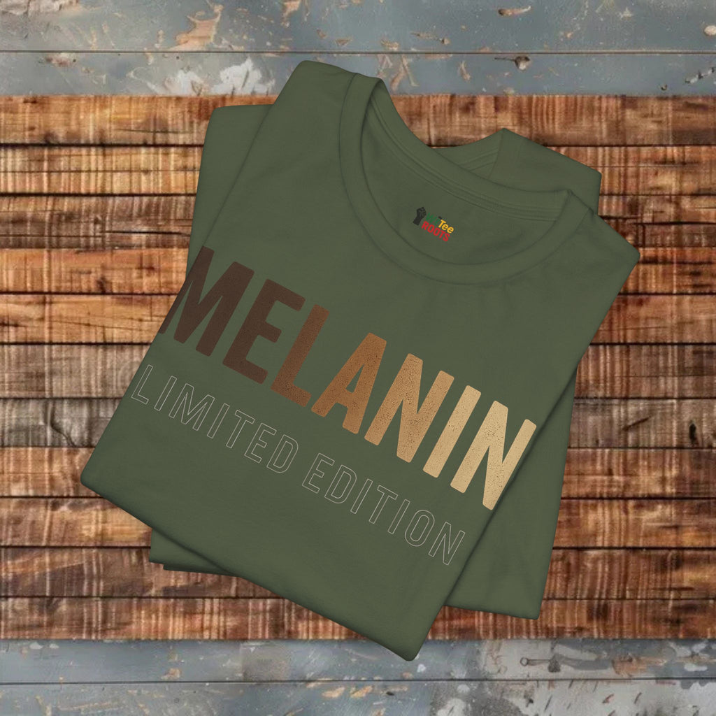 Green sweatshirt with 'MELANIN LIMITED EDITION' text on a wooden surface