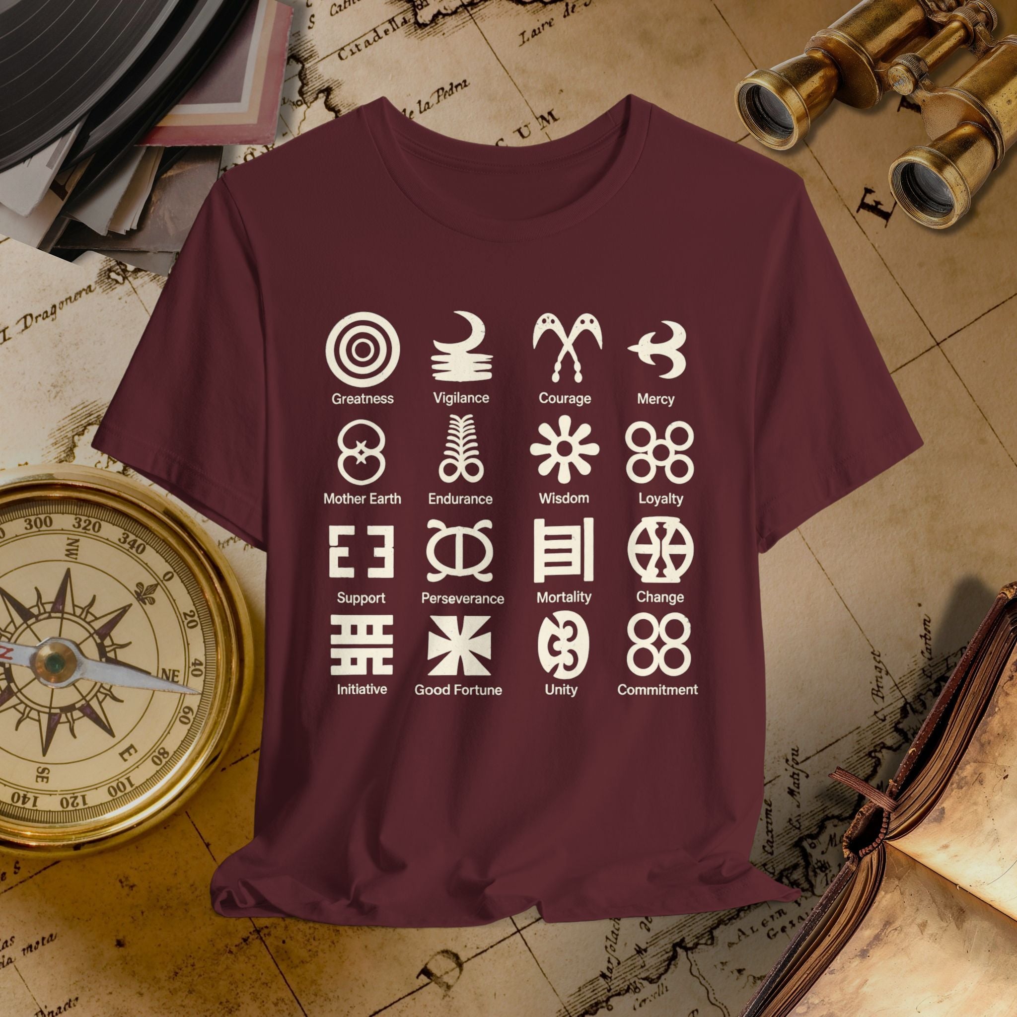 Maroon t-shirt with white symbols and text on a vintage map background