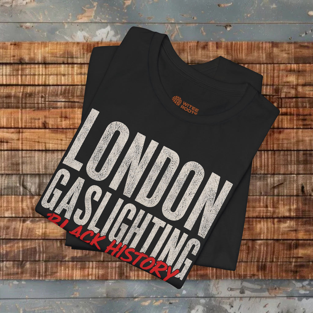 Black t-shirt with 'London Gaslighting Black History' text on a wooden surface