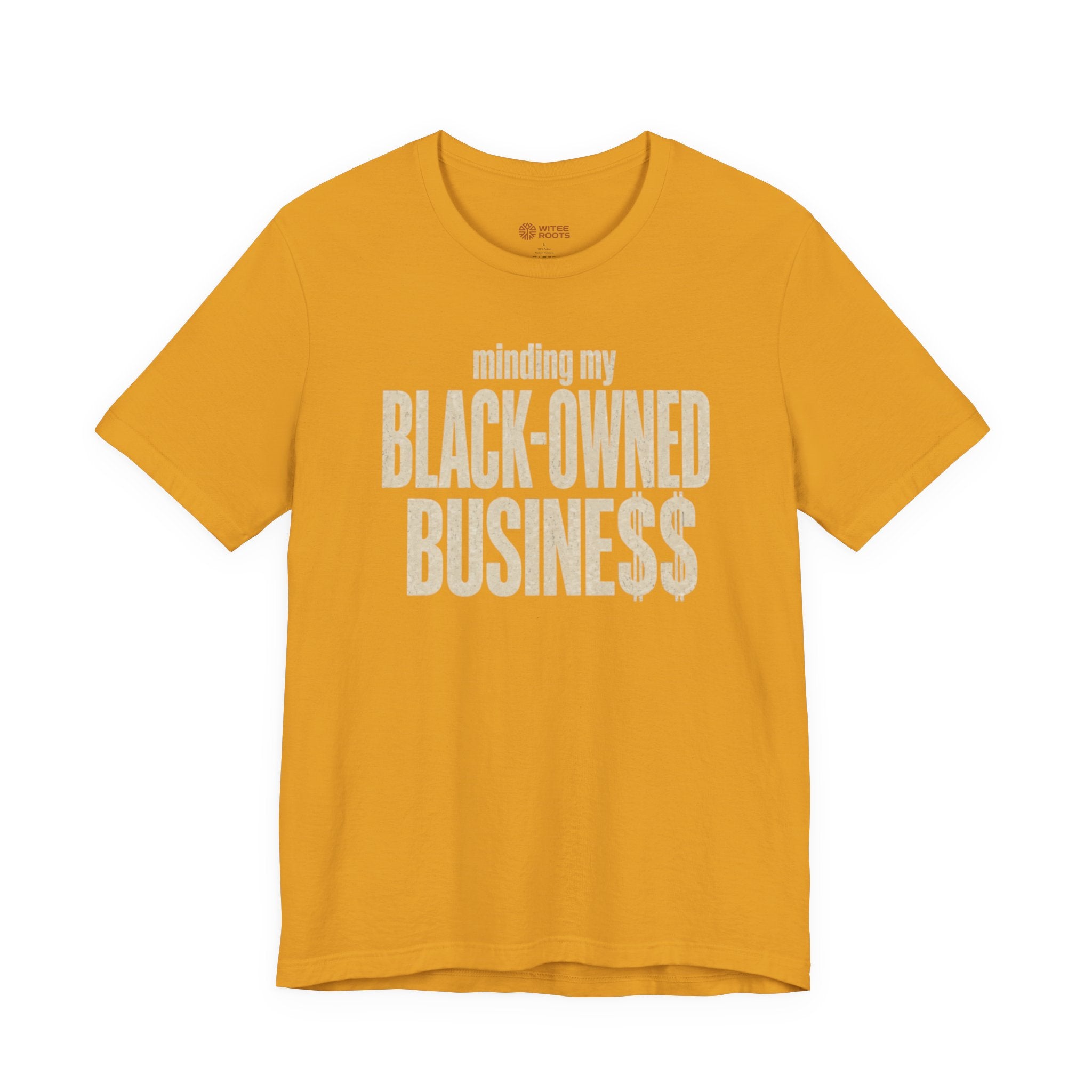 A mustard yellow short-sleeve t-shirt with a distressed white graphic print on the front reading 'minding my BLACK-OWNED BUSINESS$'.