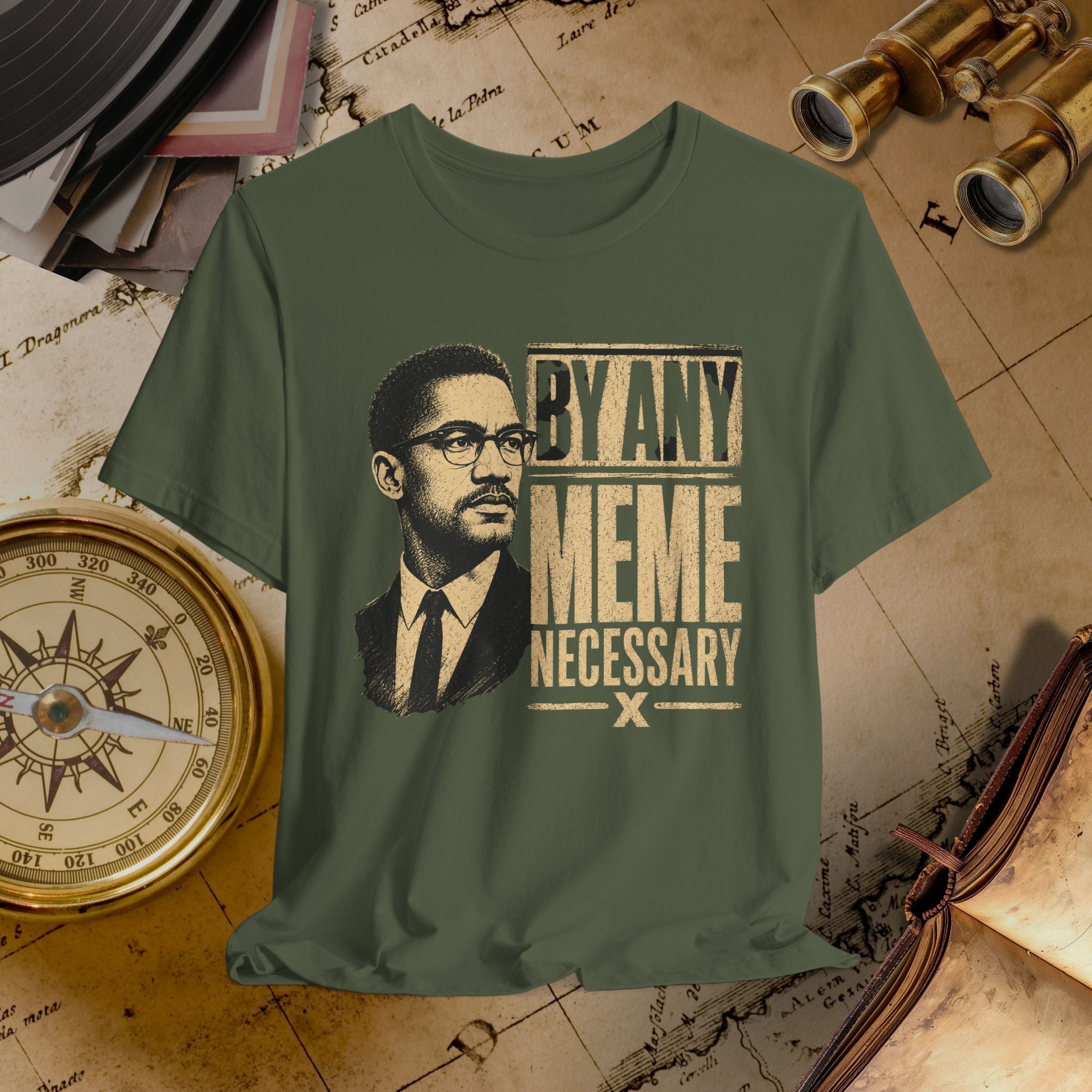Green t-shirt with a graphic of a man and text 'By Any Meme Necessary' on a vintage map background.