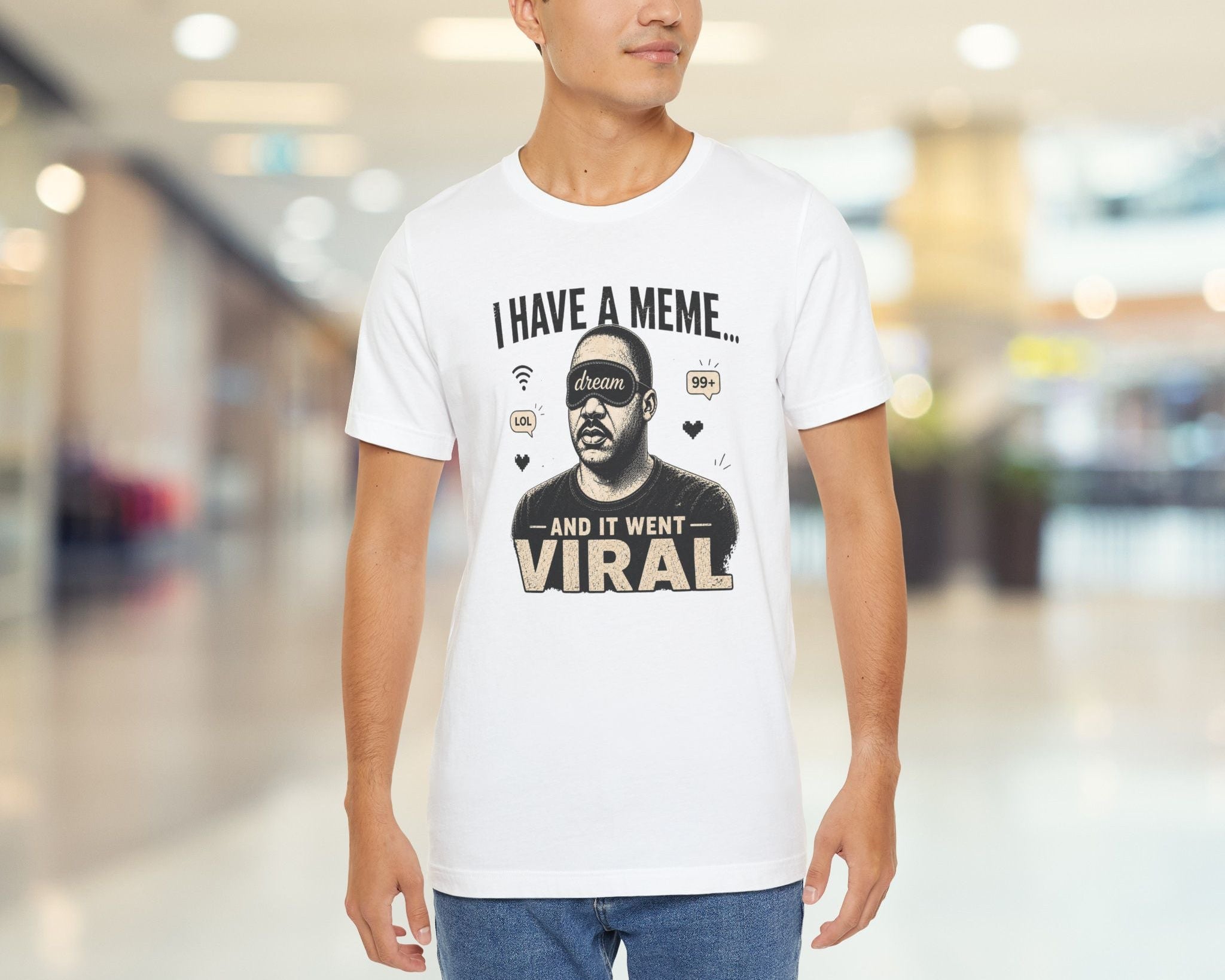 Man wearing a white t-shirt with a graphic design and text in a mall.