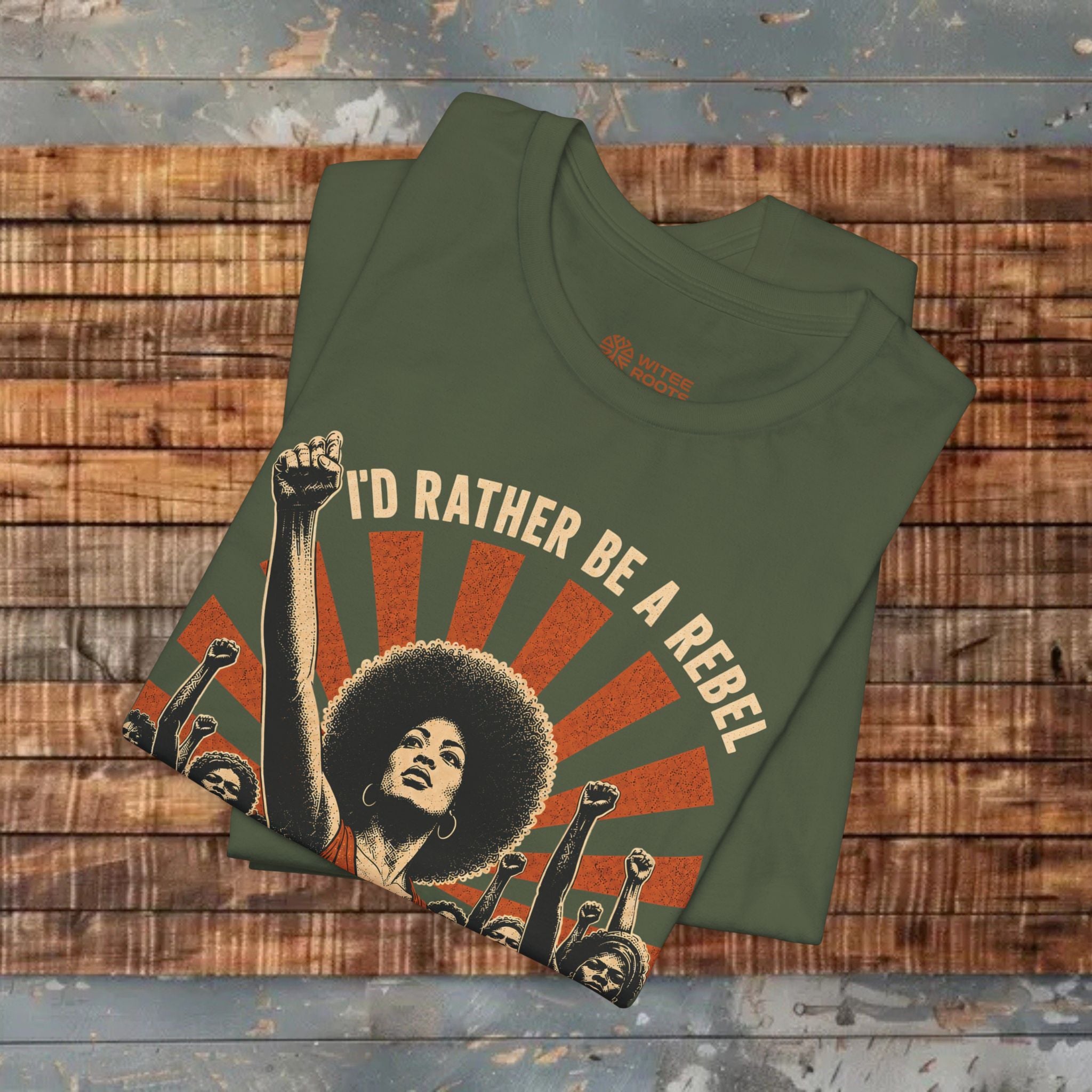 Green t-shirt with graphic design and text on a wooden surface