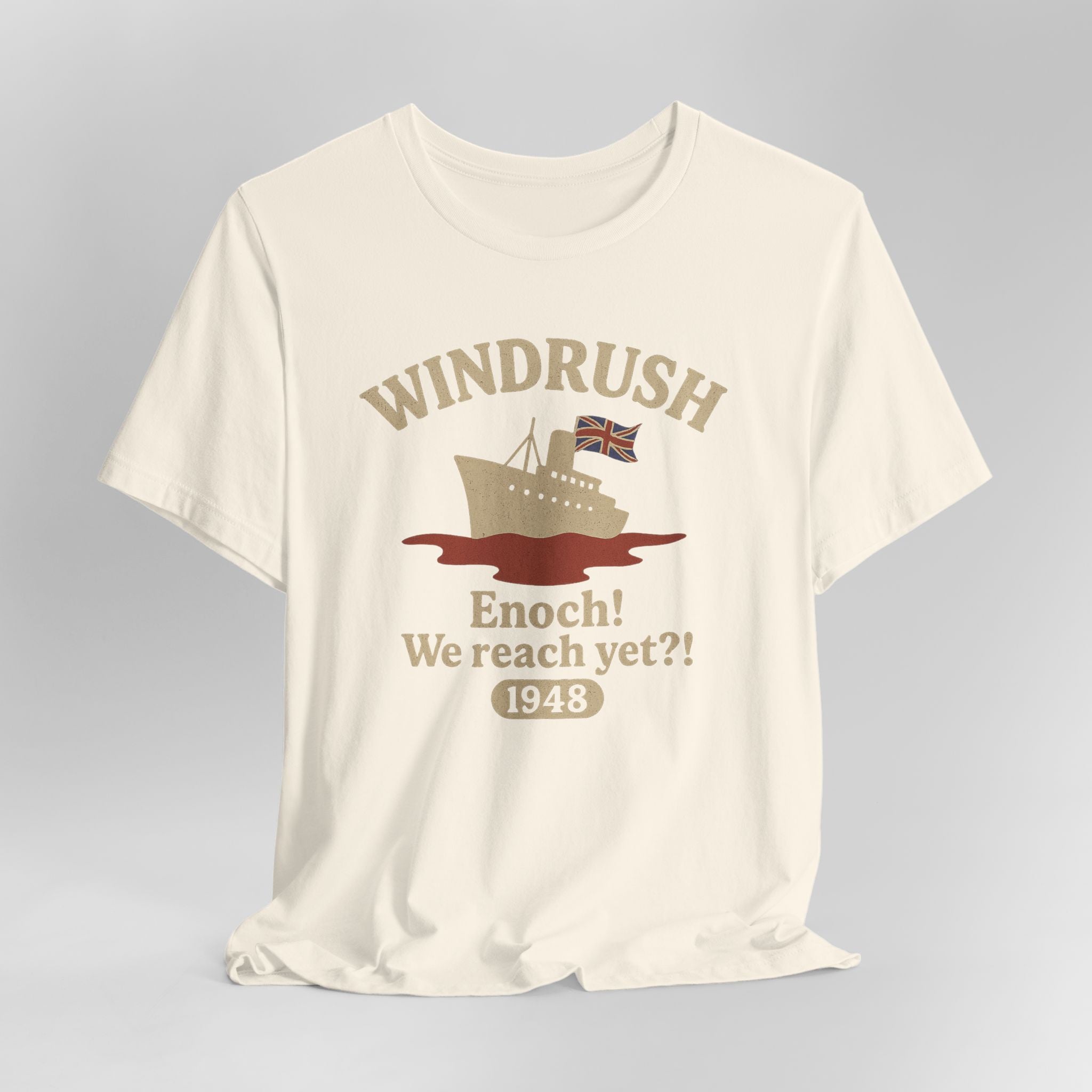 Beige t-shirt with 'Windrush' graphic and text on a gray background