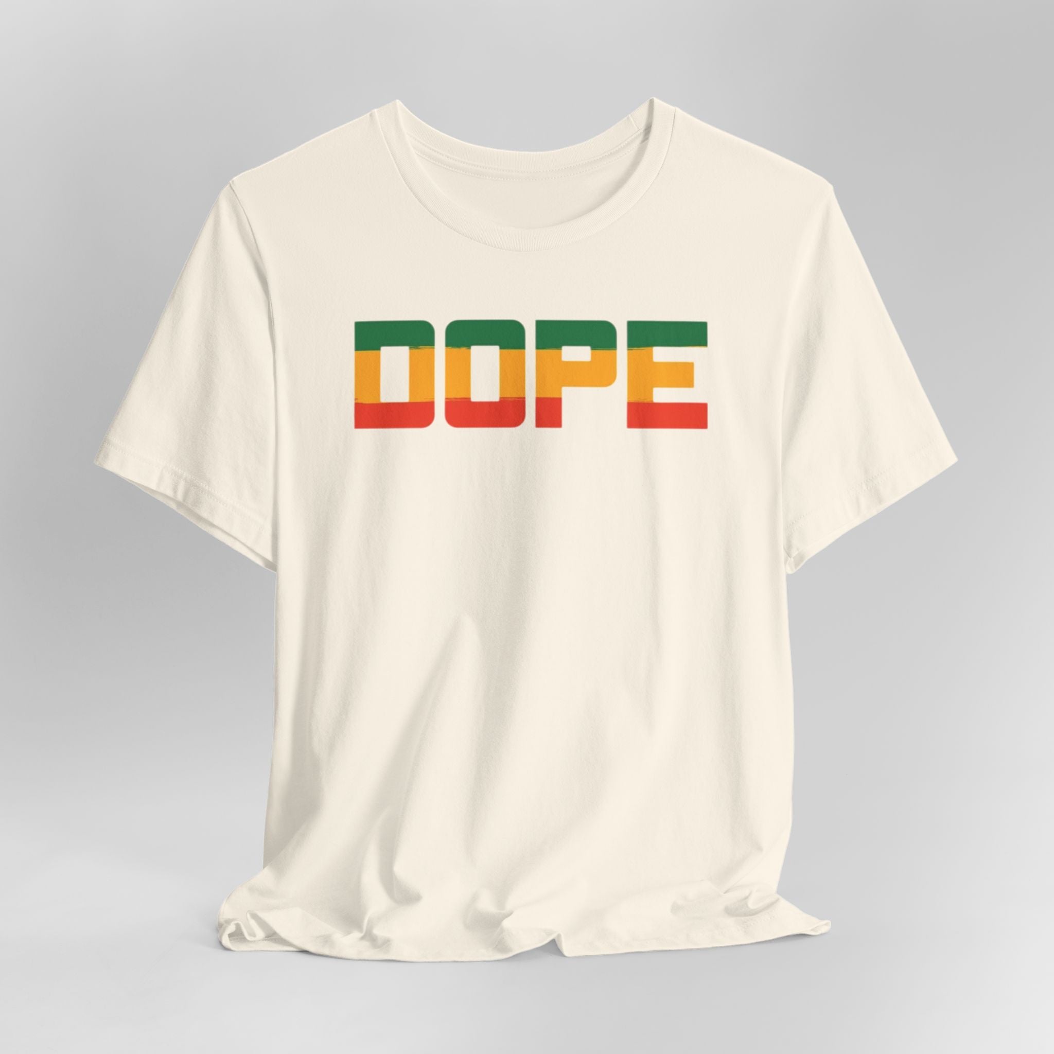 Cream t-shirt with 'DOPE' in colorful letters on a gray background