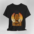 Black t-shirt with a graphic of a woman's face and 'Melanin' text on a gray background