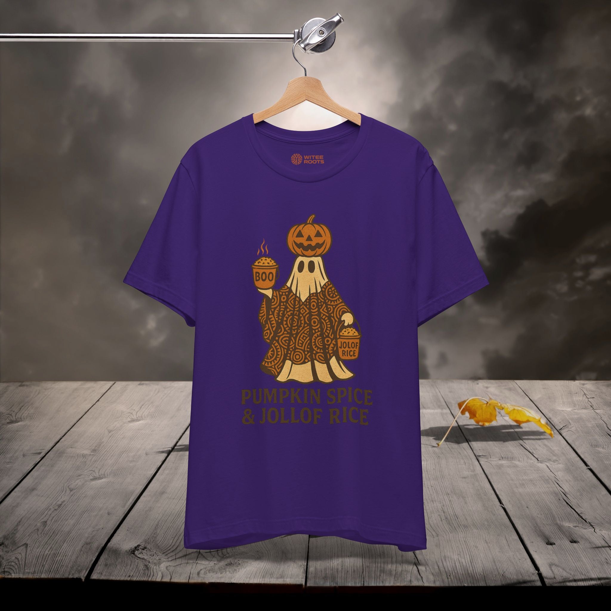 Purple t-shirt with Halloween-themed design on a wooden surface
