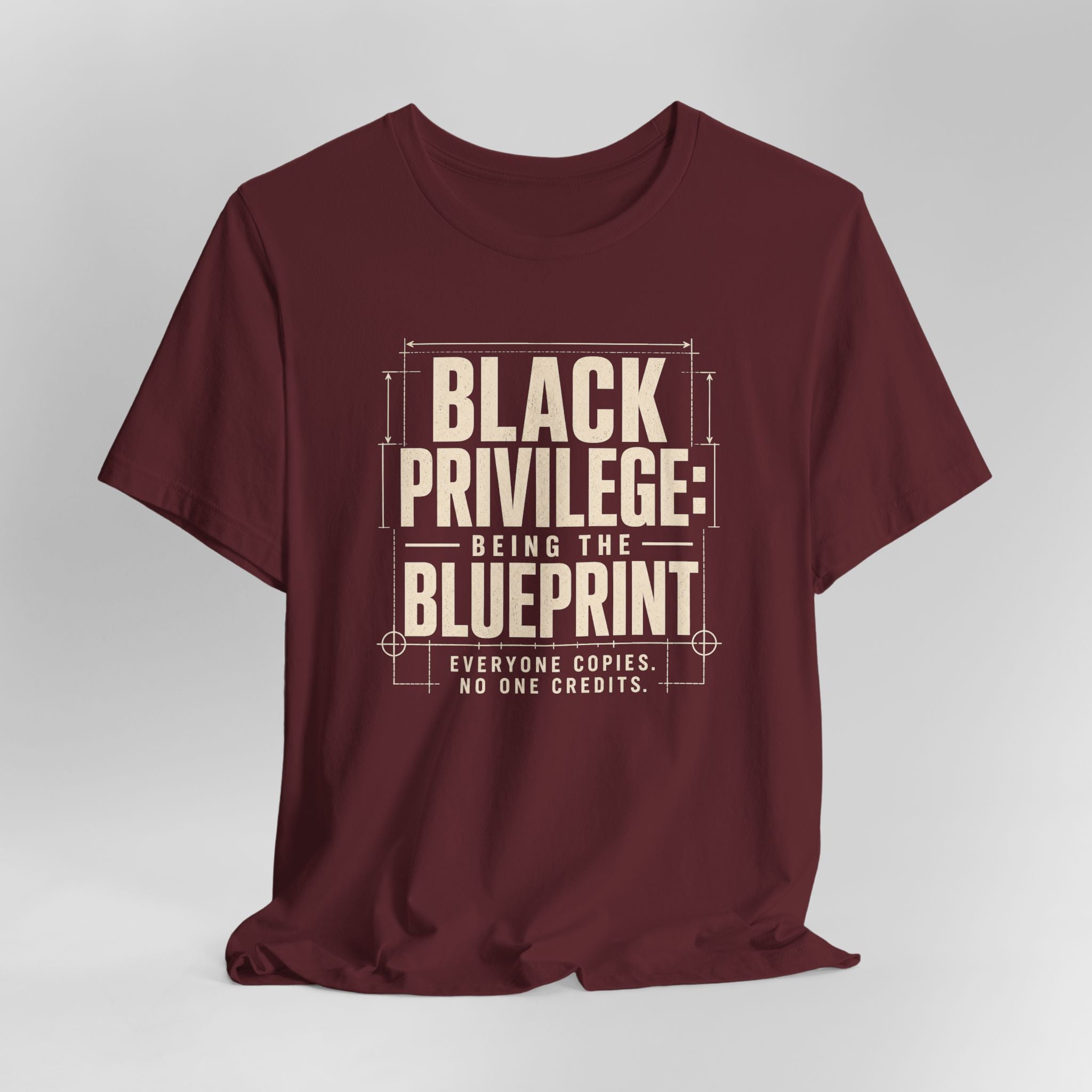 Maroon t-shirt with white text on a light gray background