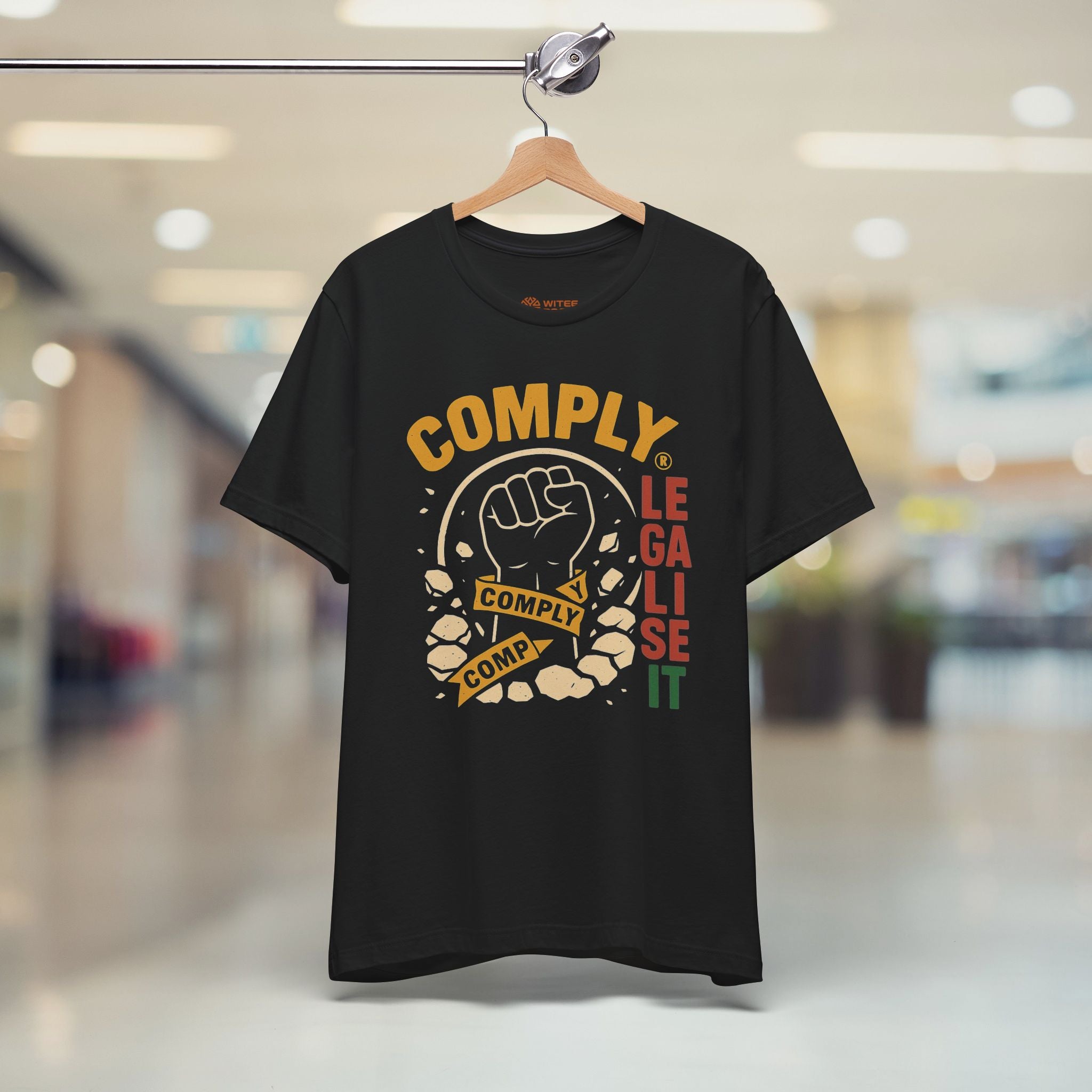 Black t-shirt with colorful graphic design on a hanger in a store setting