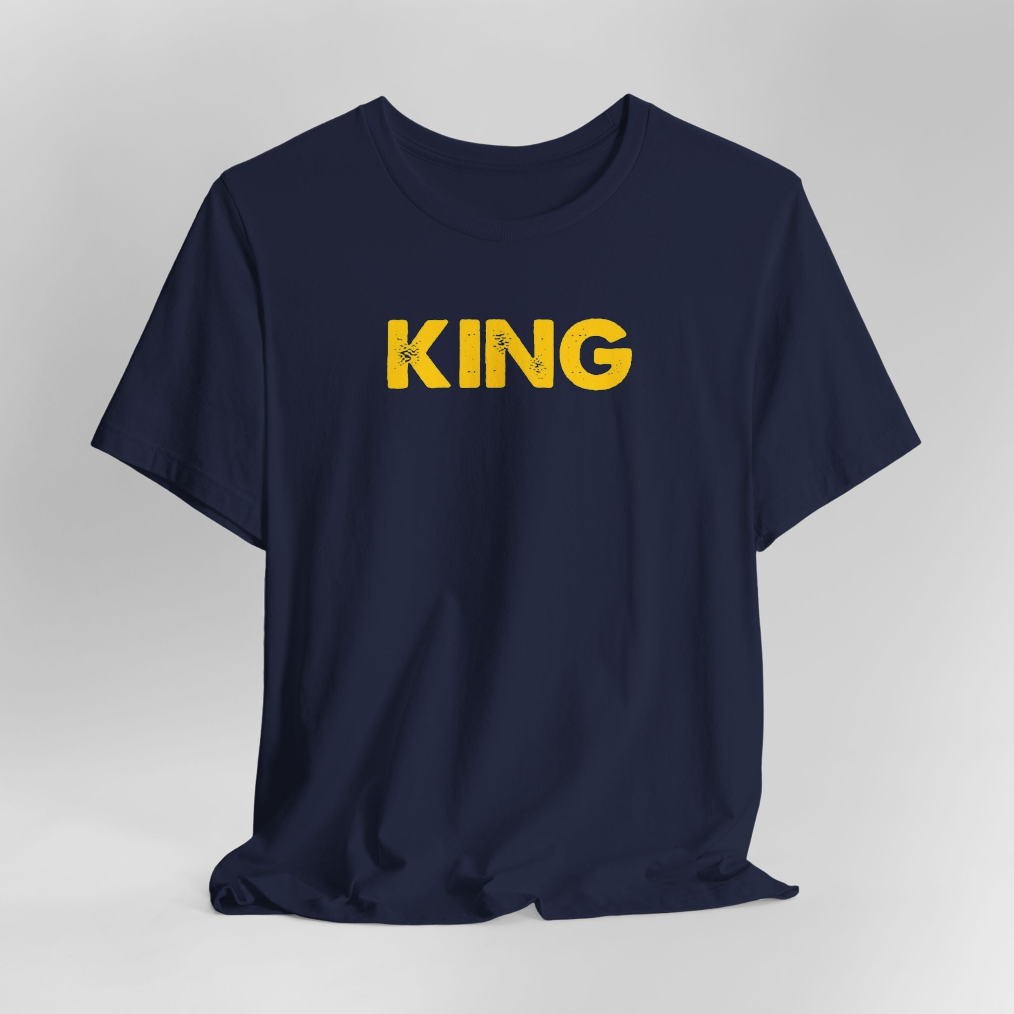 Navy blue t-shirt with 'KING' printed in yellow on a light gray background