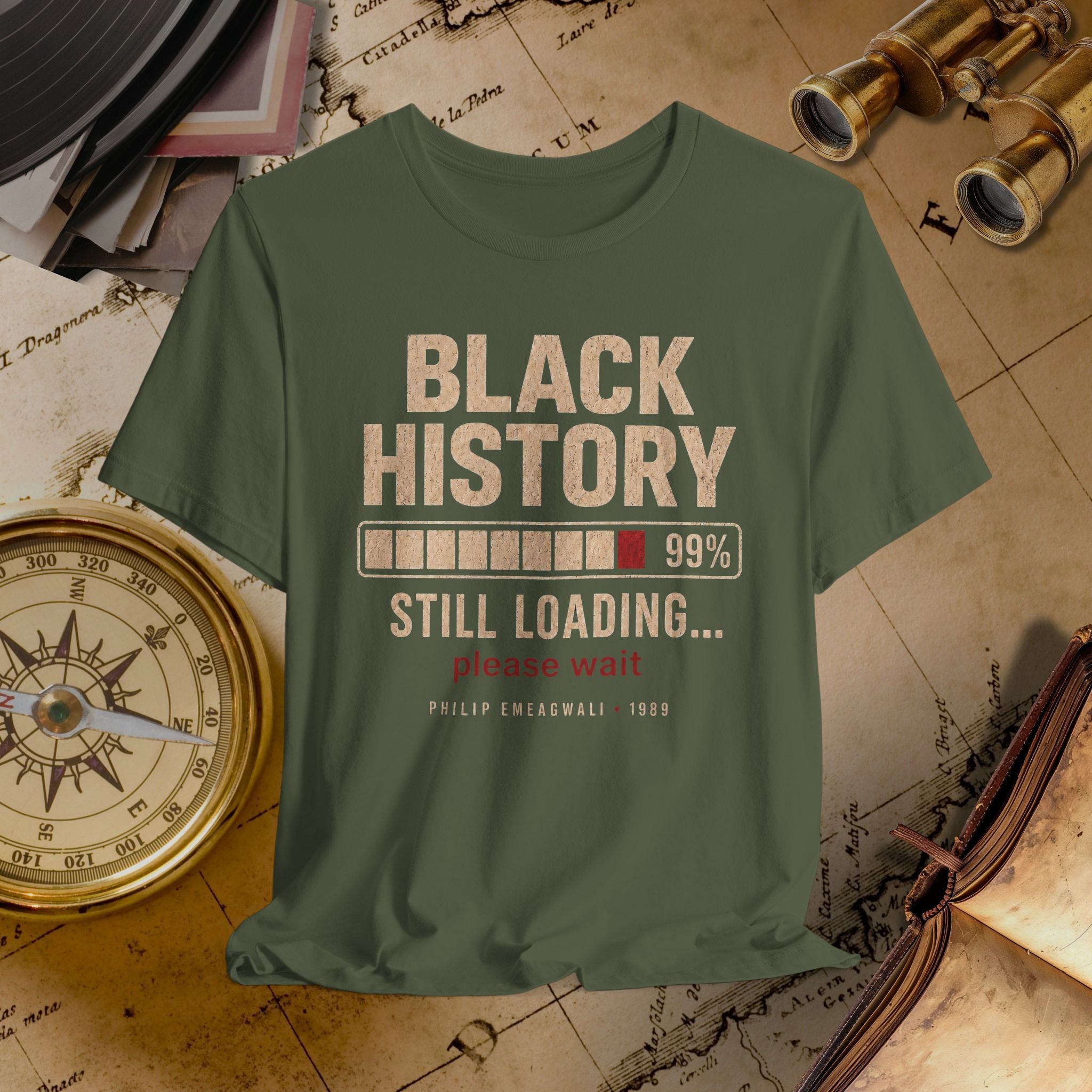 Green t-shirt with 'Black History Still Loading' text on a vintage map background