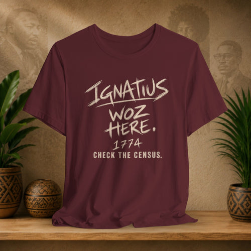 A maroon short-sleeve t-shirt with a distressed white graphic print reading 'Ignatius Woz Here. 1774 Check the Census.