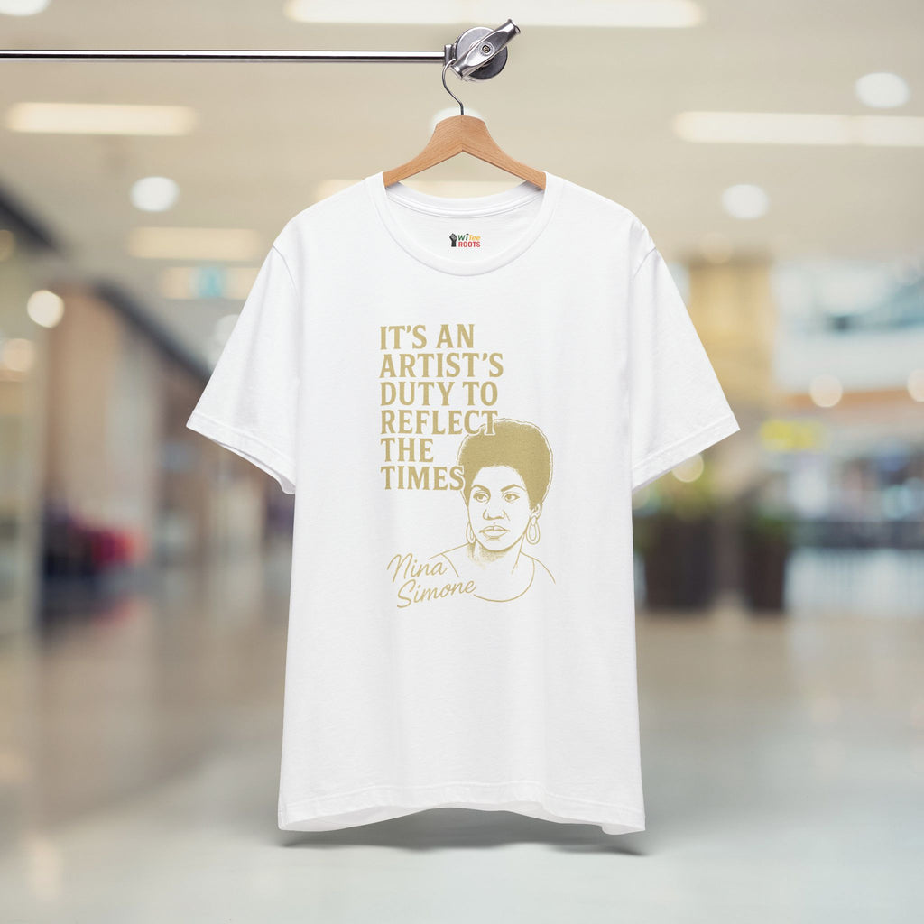 White t-shirt with gold text and a graphic of a Nina Simone on a hanger in a store.
