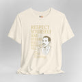 Beige t-shirt with gold text and a graphic of a man on a gray background