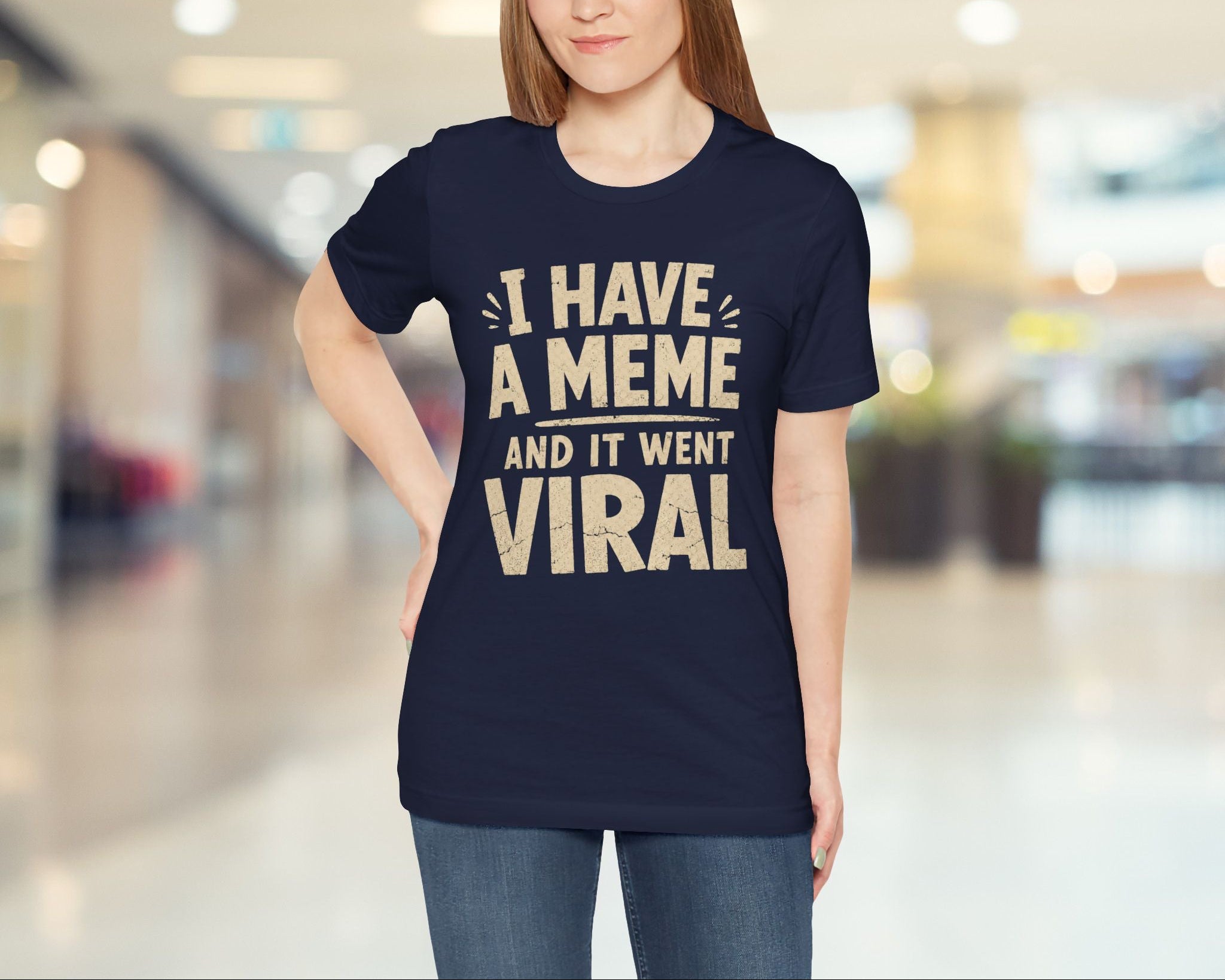 Woman wearing a navy blue t-shirt with humorous text in a blurred indoor setting