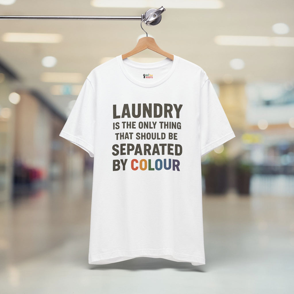 White t-shirt with humorous text on a hanger in a blurred indoor setting