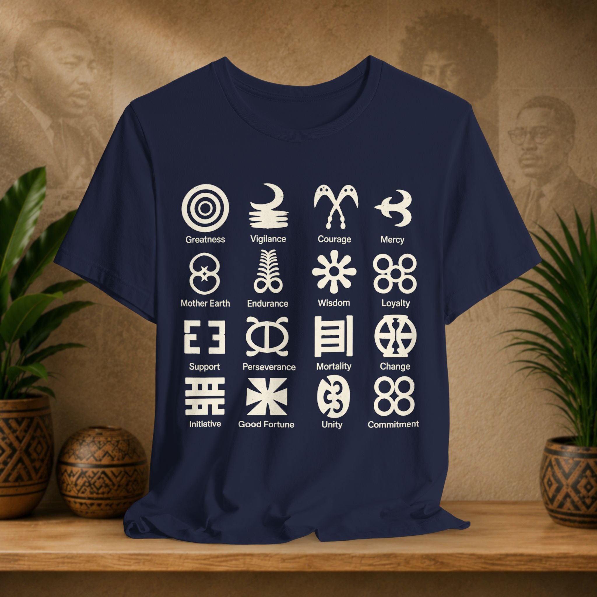 Navy blue t-shirt with white symbols and text on a wooden surface with plants and decorative items.