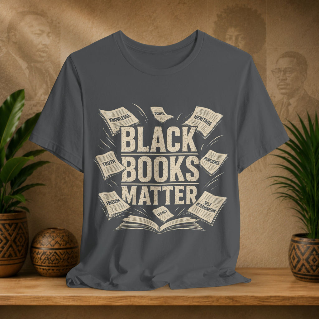 Gray t-shirt with 'Black Books Matter' design on a wooden surface with plants and decorative items.