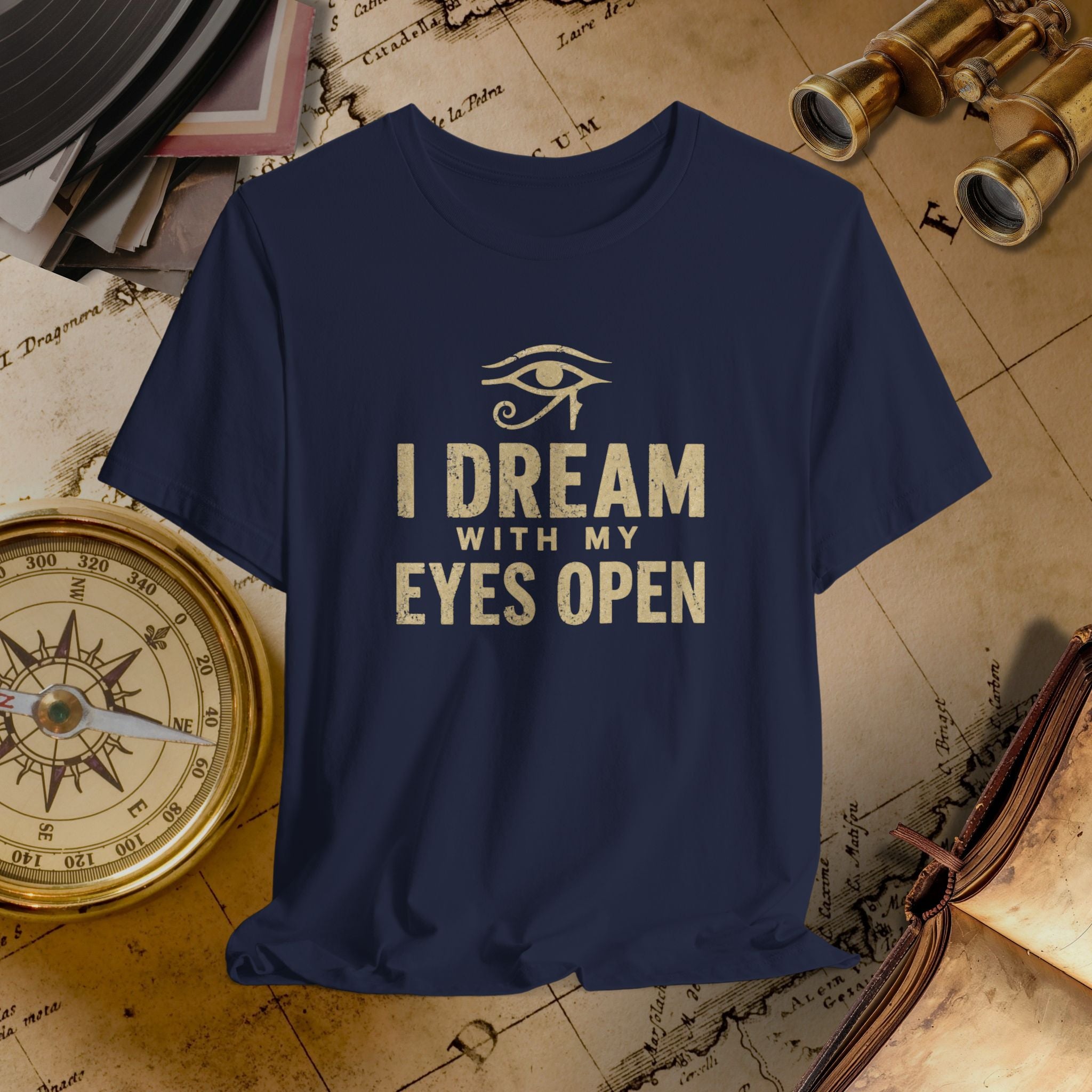 Navy blue t-shirt with 'I Dream with My Eyes Open' text and eye symbol on a vintage map background.