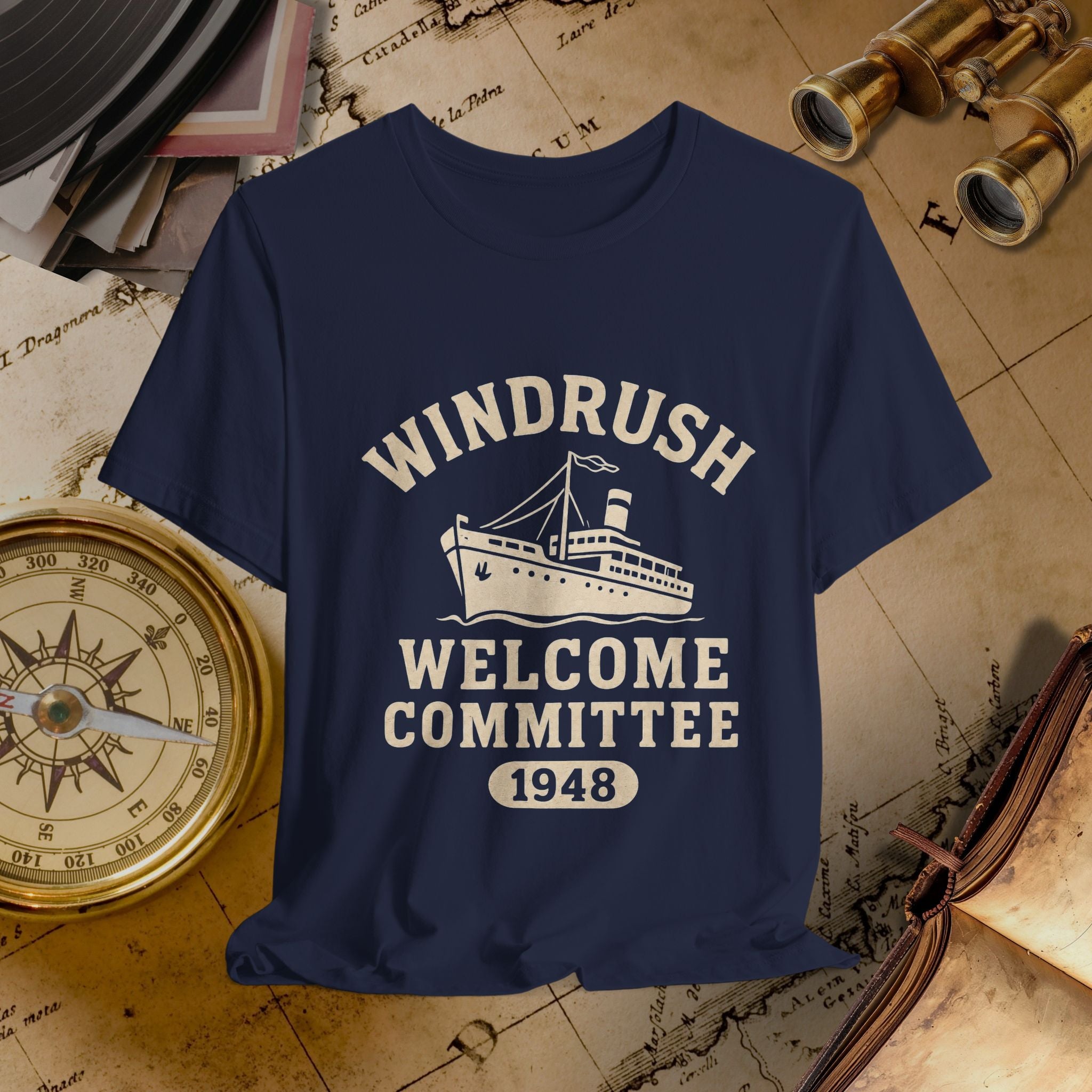 Navy blue t-shirt with 'Windrush Welcome Committee 1948' design on a vintage map background.