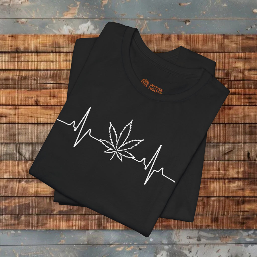Black t-shirt with white cannabis leaf and heartbeat line design on a wooden surface