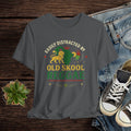 Gray t-shirt with 'Old Skool Reggae' design on a wooden surface with jeans and sneakers.
