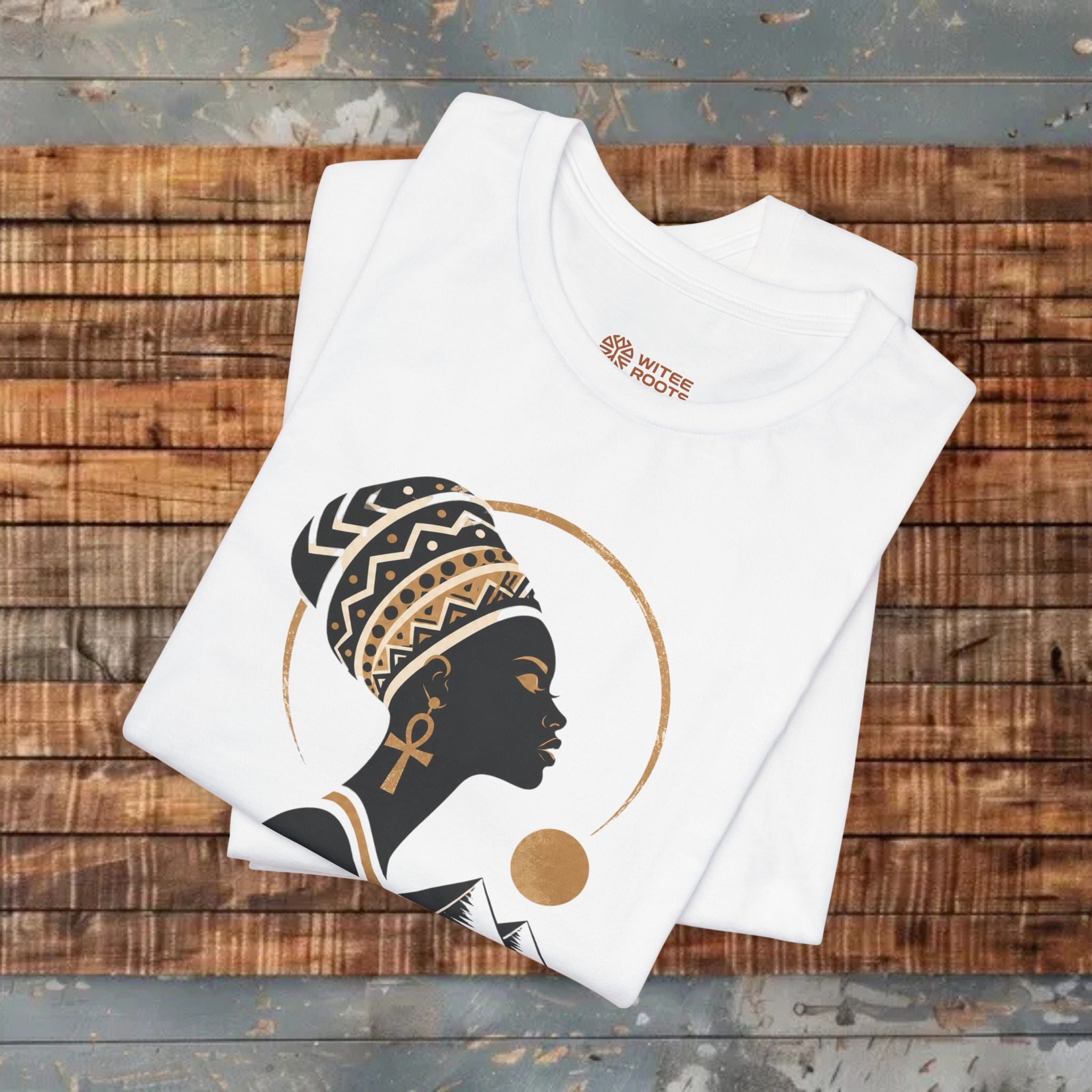 White tank top with a graphic design of a woman's profile on a wooden surface