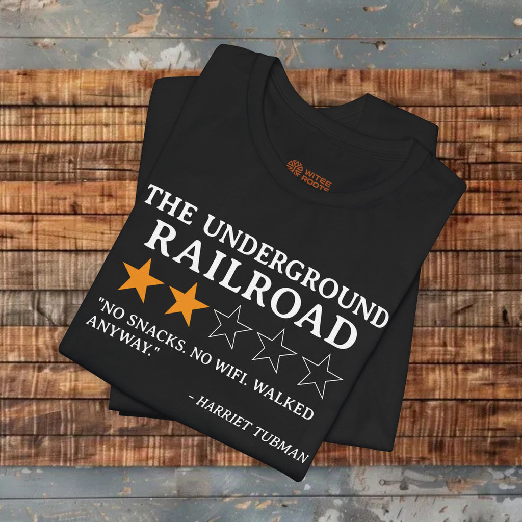 Black t-shirt with text and stars on a wooden surface