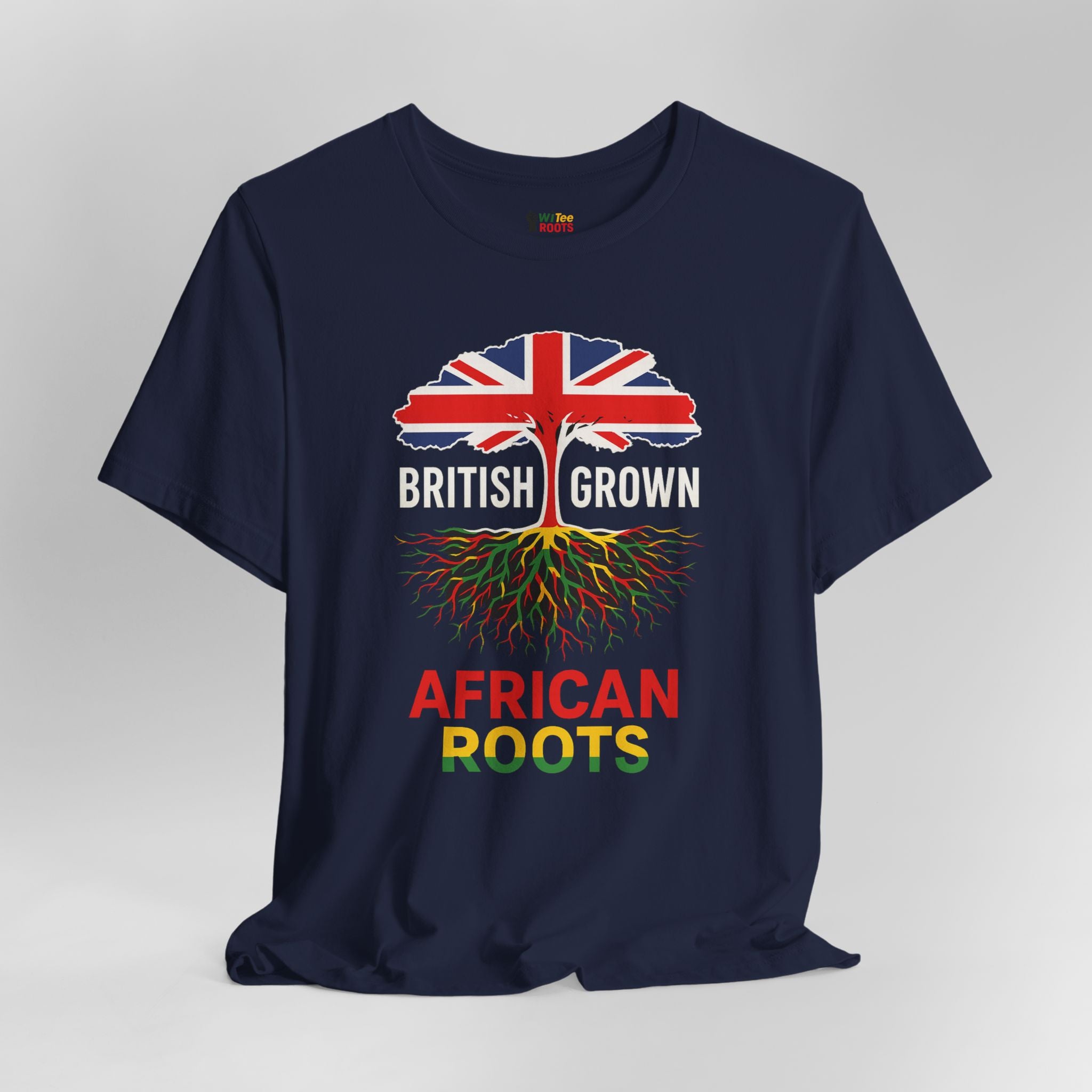 Navy blue t-shirt with a design of a tree with roots and British flag, text 'BRITISH GROWN AFRICAN ROOTS' on a gray background.