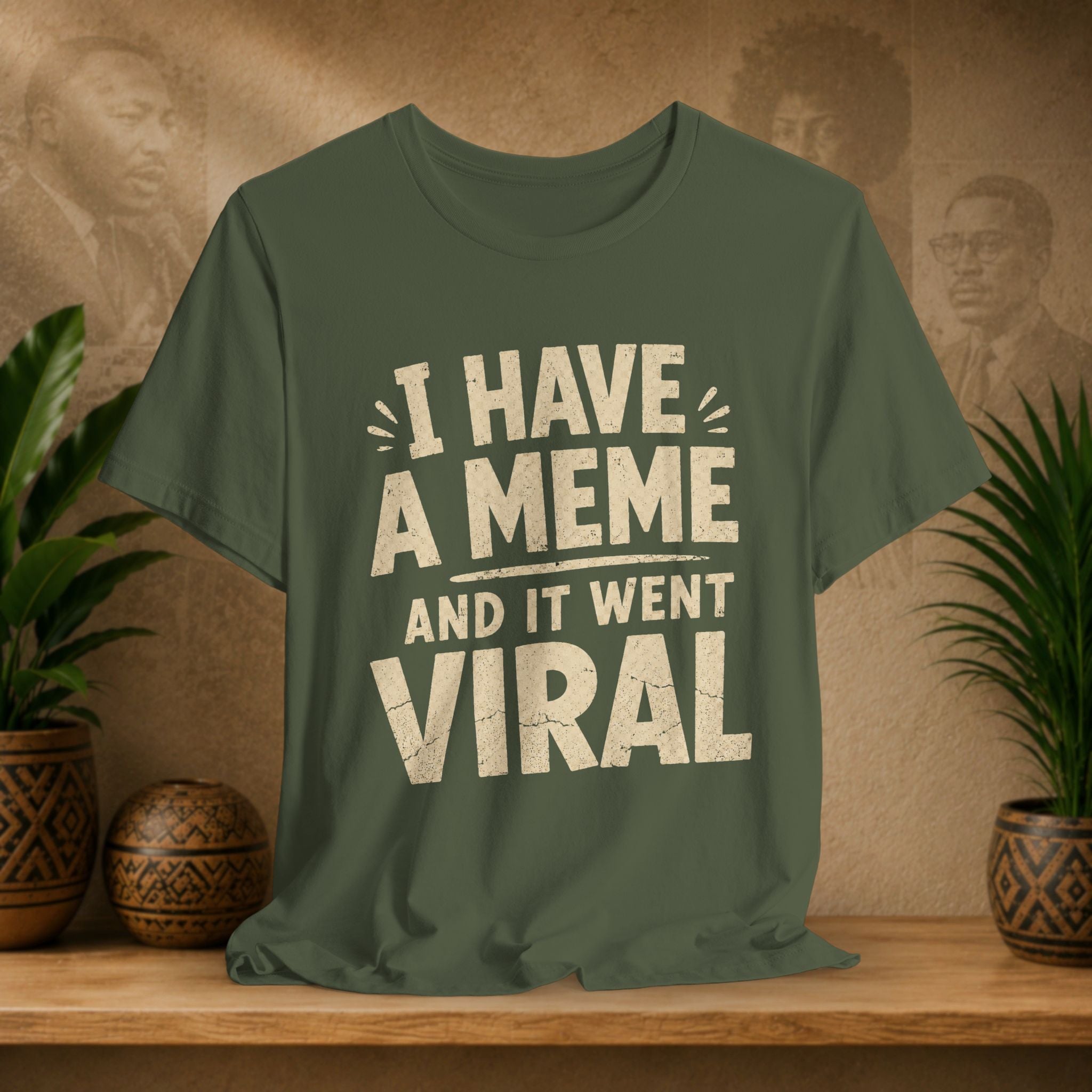 Green t-shirt with 'I have a meme and it went viral' text on a wooden surface with a vintage-style background.