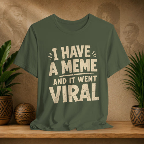 Green t-shirt with 'I have a meme and it went viral' text on a wooden surface with a vintage-style background.