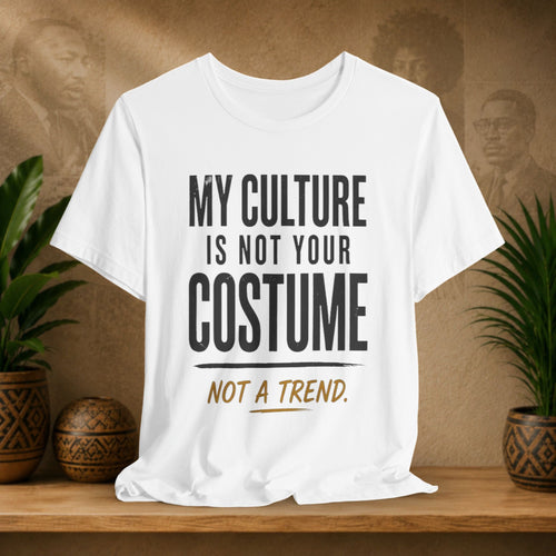 White t-shirt design on a wooden surface with plants and a decorative wall.