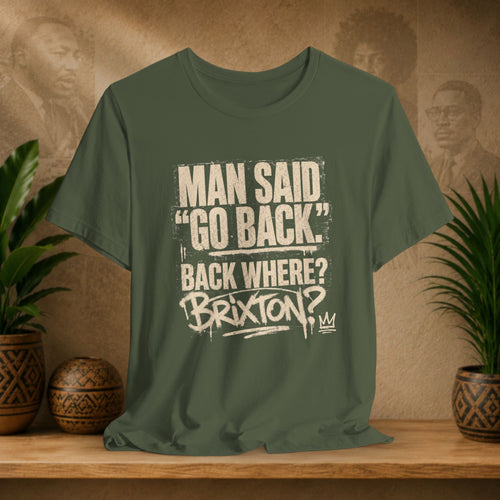 Green t-shirt with text on a wooden surface with plants and a textured wall background