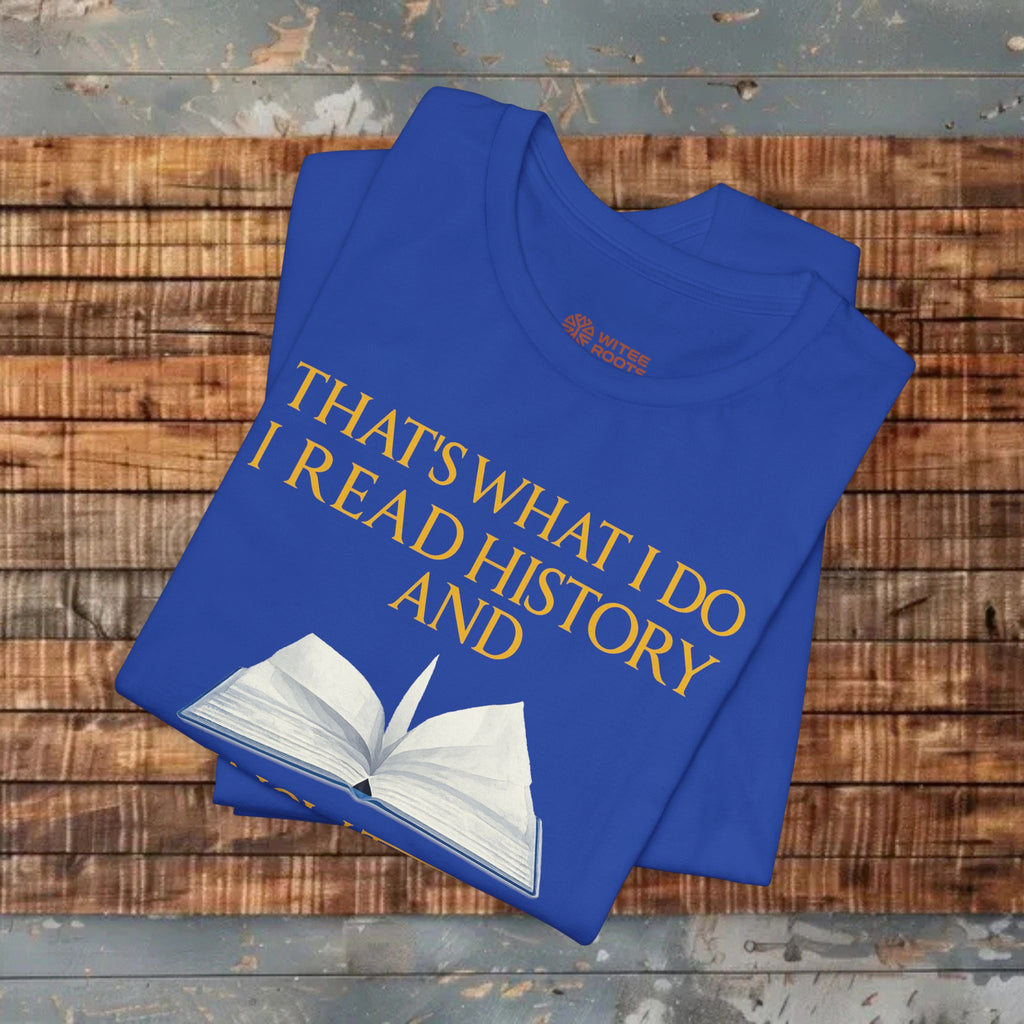 Blue t-shirt with yellow text and an open book graphic on a wooden surface