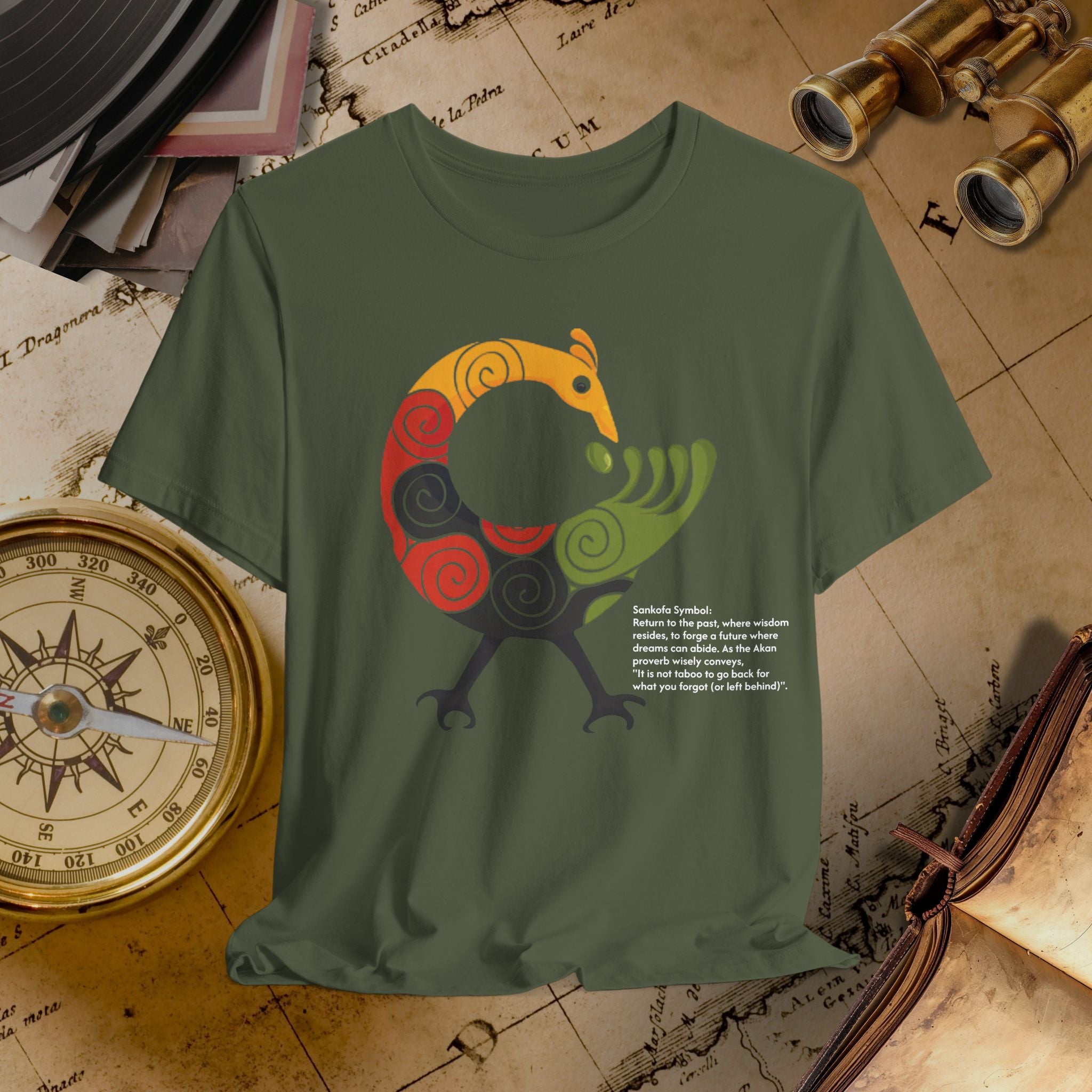 Green t-shirt with a colorful dragon design on a vintage map background