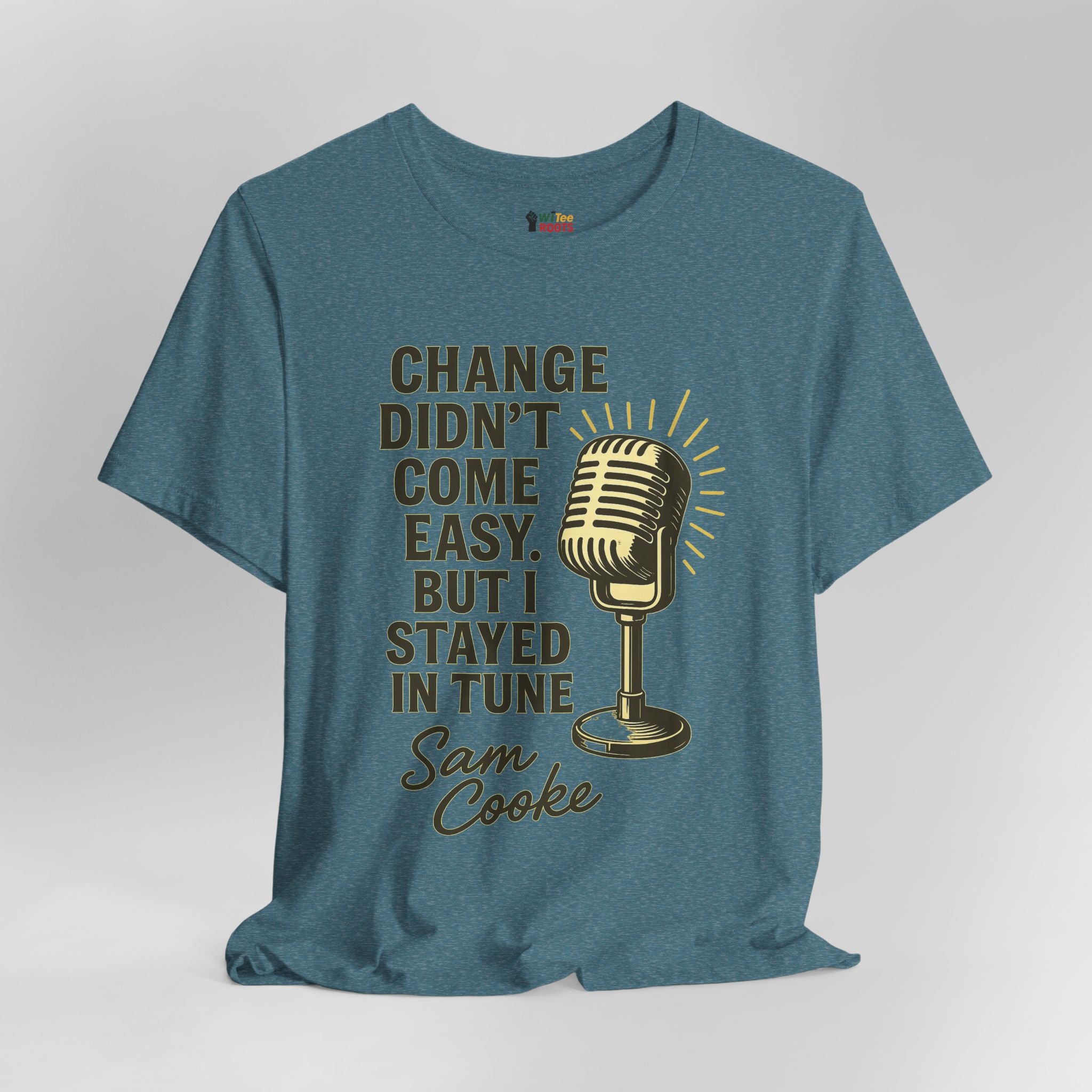 Blue t-shirt with a gold microphone graphic and text on a gray background