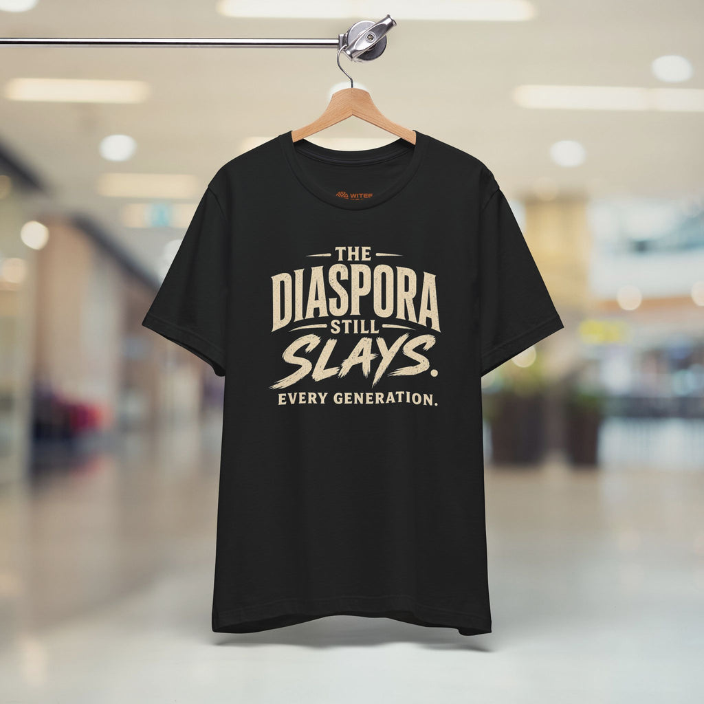 Black t-shirt with 'The Diaspora Still Slays Every Generation' text on a hanger.