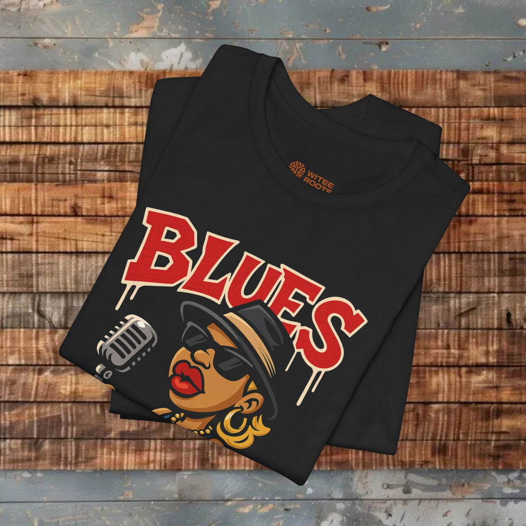 Black t-shirt with 'BLUES' design on a wooden surface