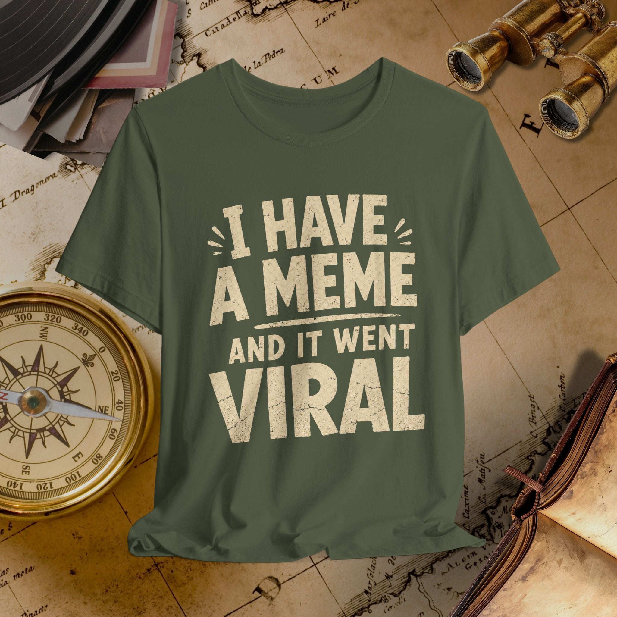 Green t-shirt with 'I have a meme and it went viral' text on a vintage map background