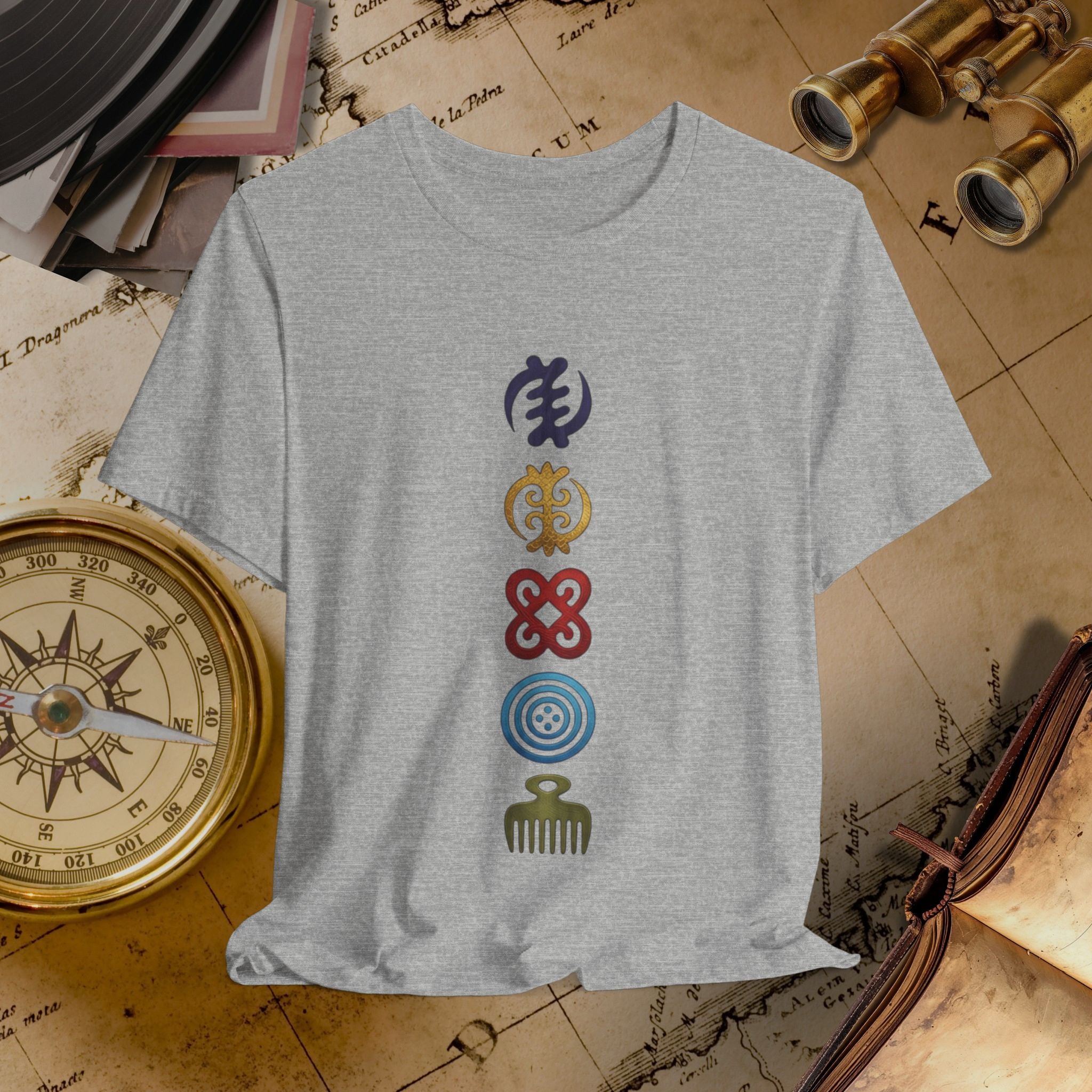 Gray t-shirt with colorful symbols on a vintage map background