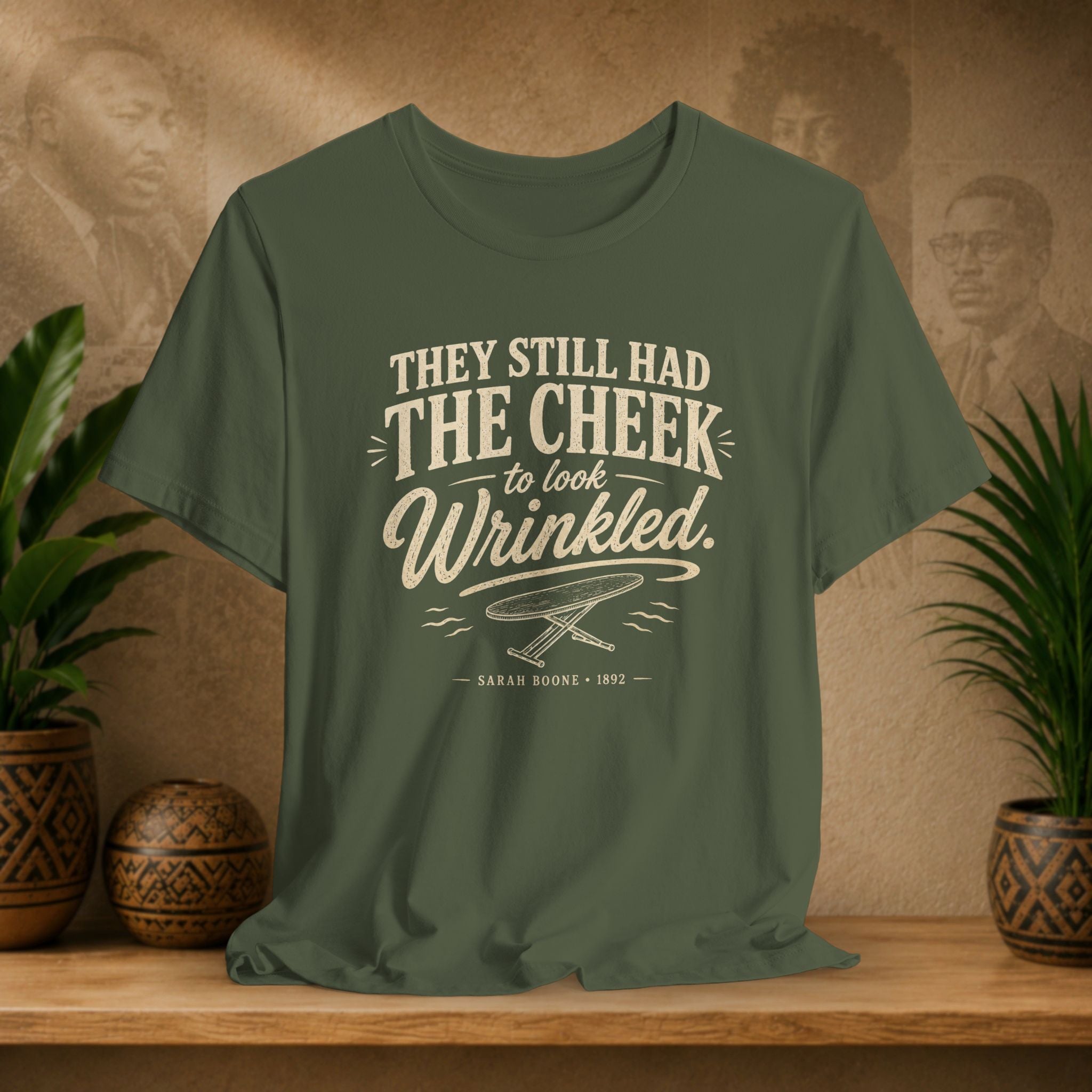 Green t-shirt with text on a wooden surface with plants and a vintage-style background