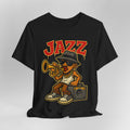Black t-shirt with a cartoon character playing a trumpet and the word 'Jazz' on a gray background