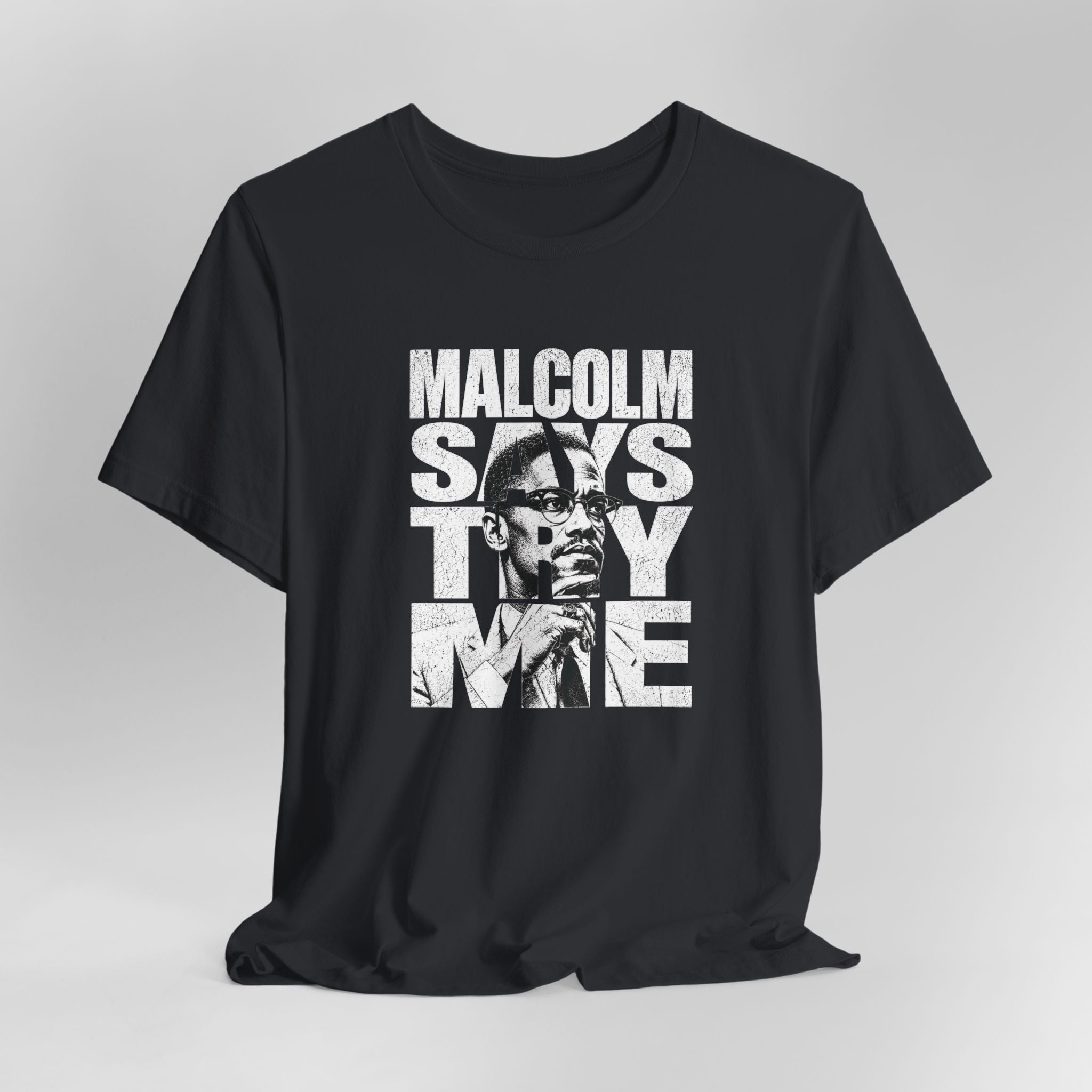 Black t-shirt with graphic design and text on a gray background