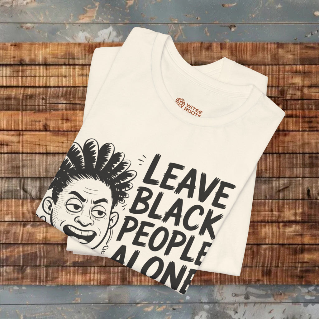 White t-shirt with graphic design and text on a wooden surface