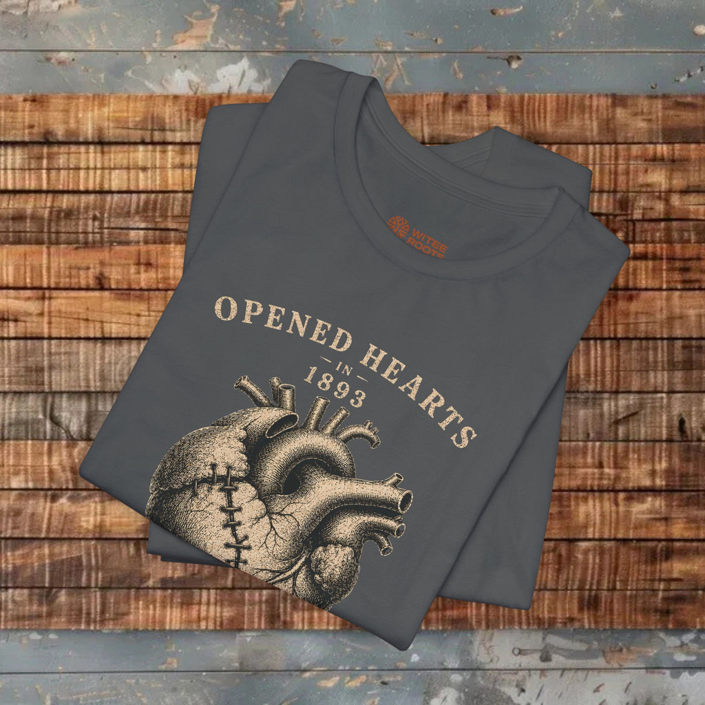 Folded t-shirt with heart design and text on a wooden surface
